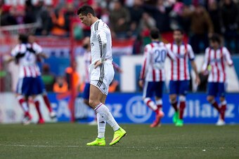 MADRID, SPAIN - FEBRUARY 07:  Cristiano Ronaldo of Real Madrid CF reacts defeated as behind Mario Mandzukic of Atletico de Madrid celebrates scoring their fourth goal with teammates during the La Liga match between Club Atletico de Madrid and Real Madrid 