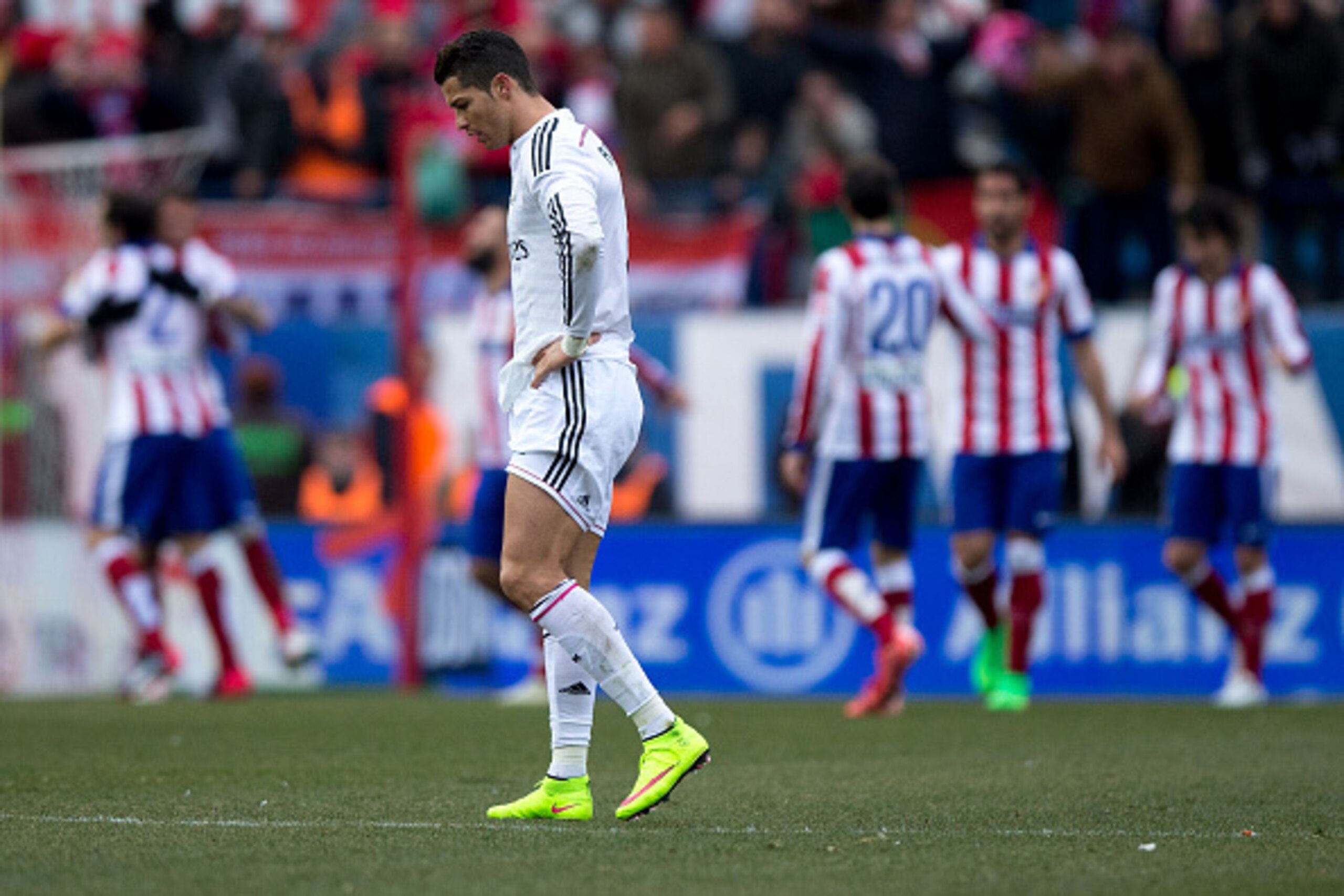 MADRID, SPAIN - FEBRUARY 07: Cristiano Ronaldo of Real Madrid CF reacts defeated as behind Mario Mandzukic of Atletico de Madrid celebrates scoring their fourth goal with teammates during the La Liga match between Club Atletico de Madrid and Real Madrid MADRID, SPAIN - FEBRUARY 07: Cristiano Ronaldo of Real Madrid CF reacts defeated as behind Mario Mandzukic of Atletico de Madrid celebrates scoring their fourth goal with teammates during the La Liga match between Club Atletico de Madrid and Real Madrid