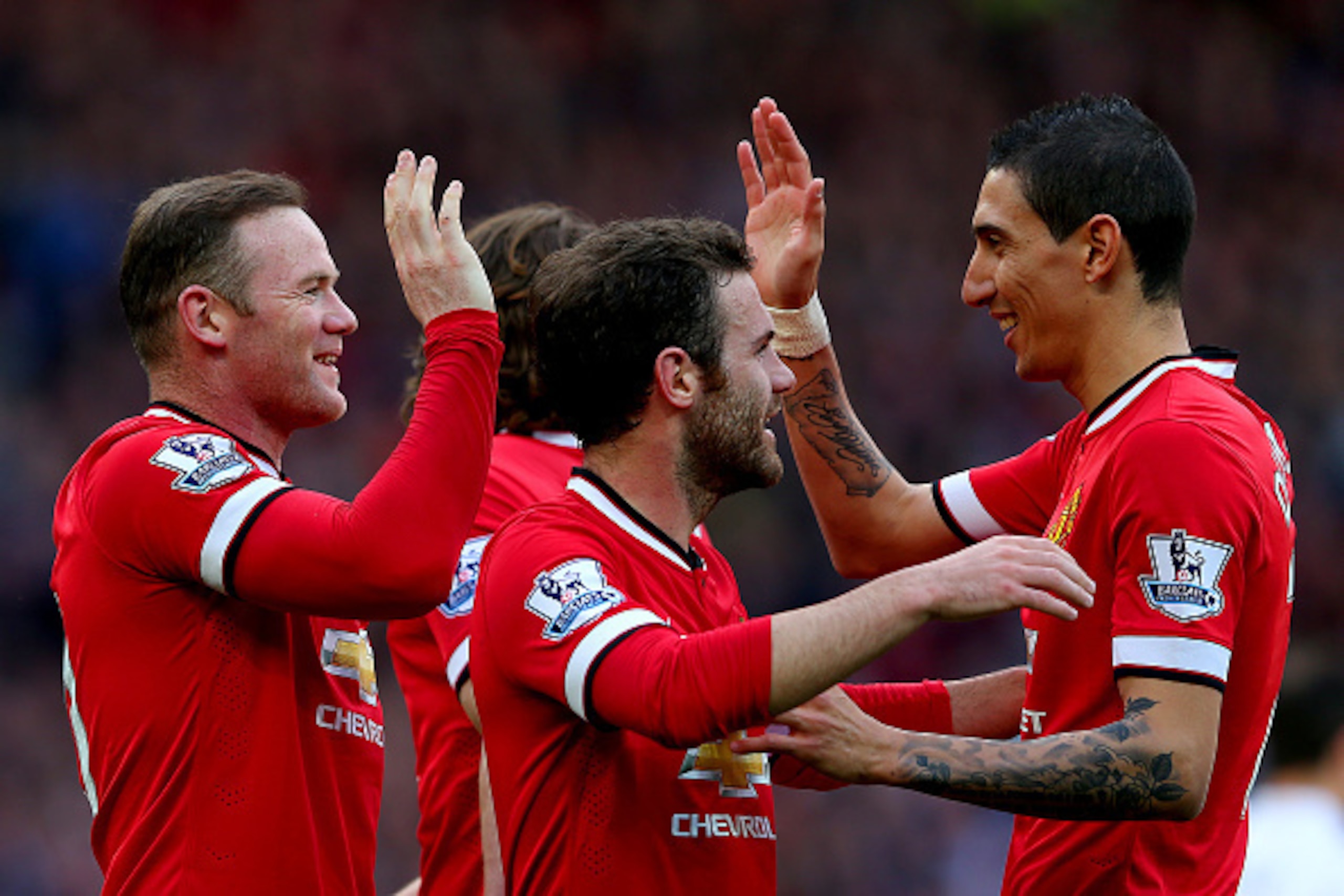 MANCHESTER, ENGLAND - APRIL 04:  Wayne Rooney of Manchester United celebrates with team-mates after scoring his team's second goal during the Barclays Premier League match between Manchester United and Aston Villa at Old Trafford on April 4, 2015 in Manch