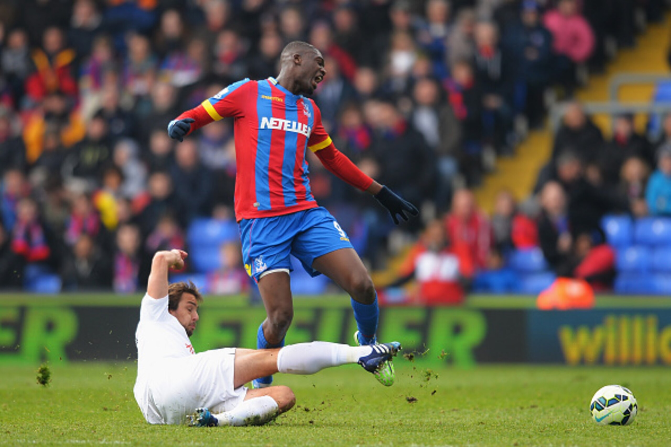 LONDON, ENGLAND - MARCH 14:  Yaya Sanogo of Crystal Palace is tackled by Niko Kranjcar of QPR during the Barclays Premier League match between Crystal Palace and Queens Park Rangers at Selhurst Park on March 14, 2015 in London, England.  (Photo by Christo