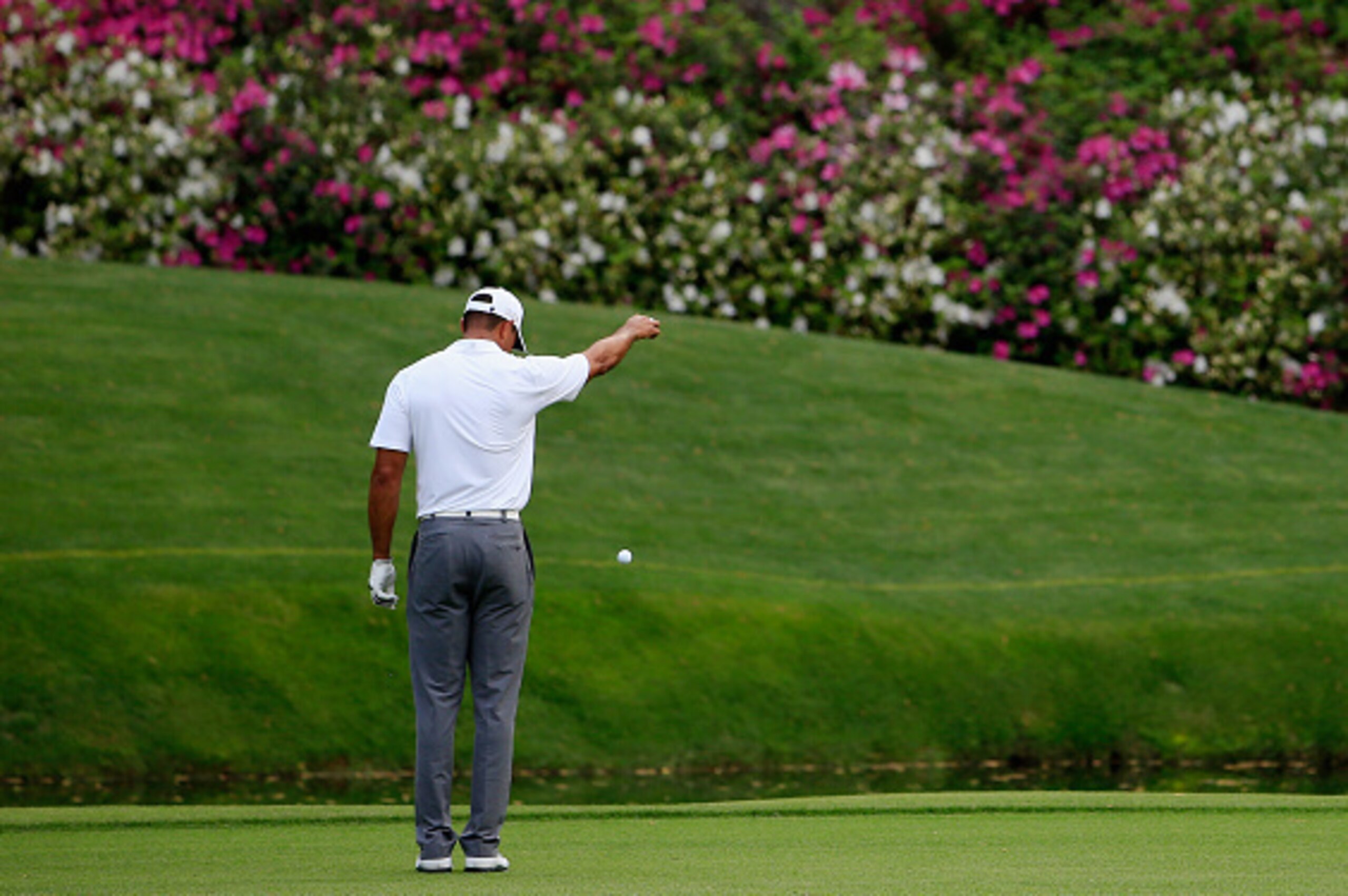 AUGUSTA, GA - APRIL 09:  Tiger Woods of the United States takes a drop after hitting a ball in the water on the 12th hole during the first round of the 2015 Masters Tournament at Augusta National Golf Club on April 9, 2015 in Augusta, Georgia.  (Photo by 