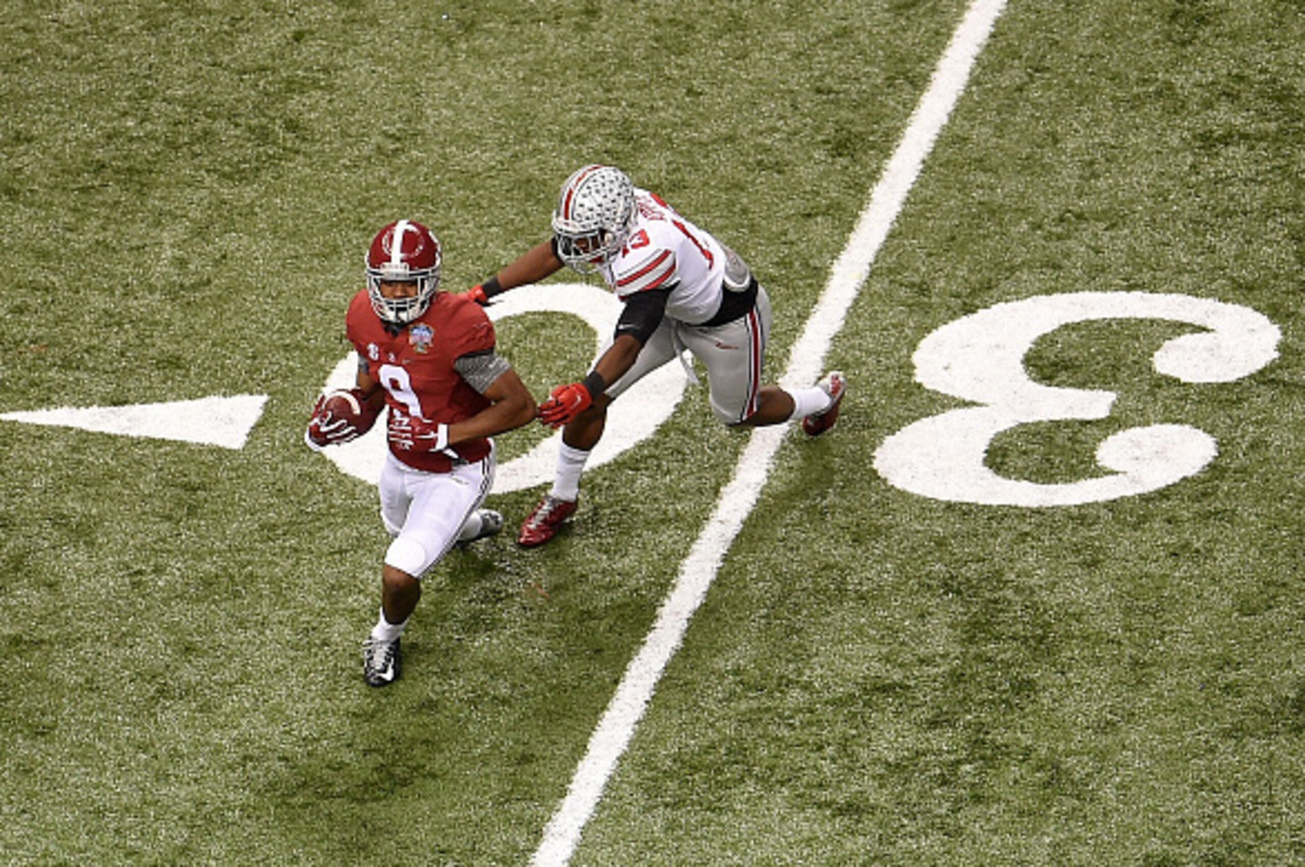NEW ORLEANS, LA - JANUARY 01:  Amari Cooper #9 of the Alabama Crimson Tide catches a pass against Eli Apple #13 of the Ohio State Buckeyes during the All State Sugar Bowl at the Mercedes-Benz Superdome on January 1, 2015 in New Orleans, Louisiana.  (Photo