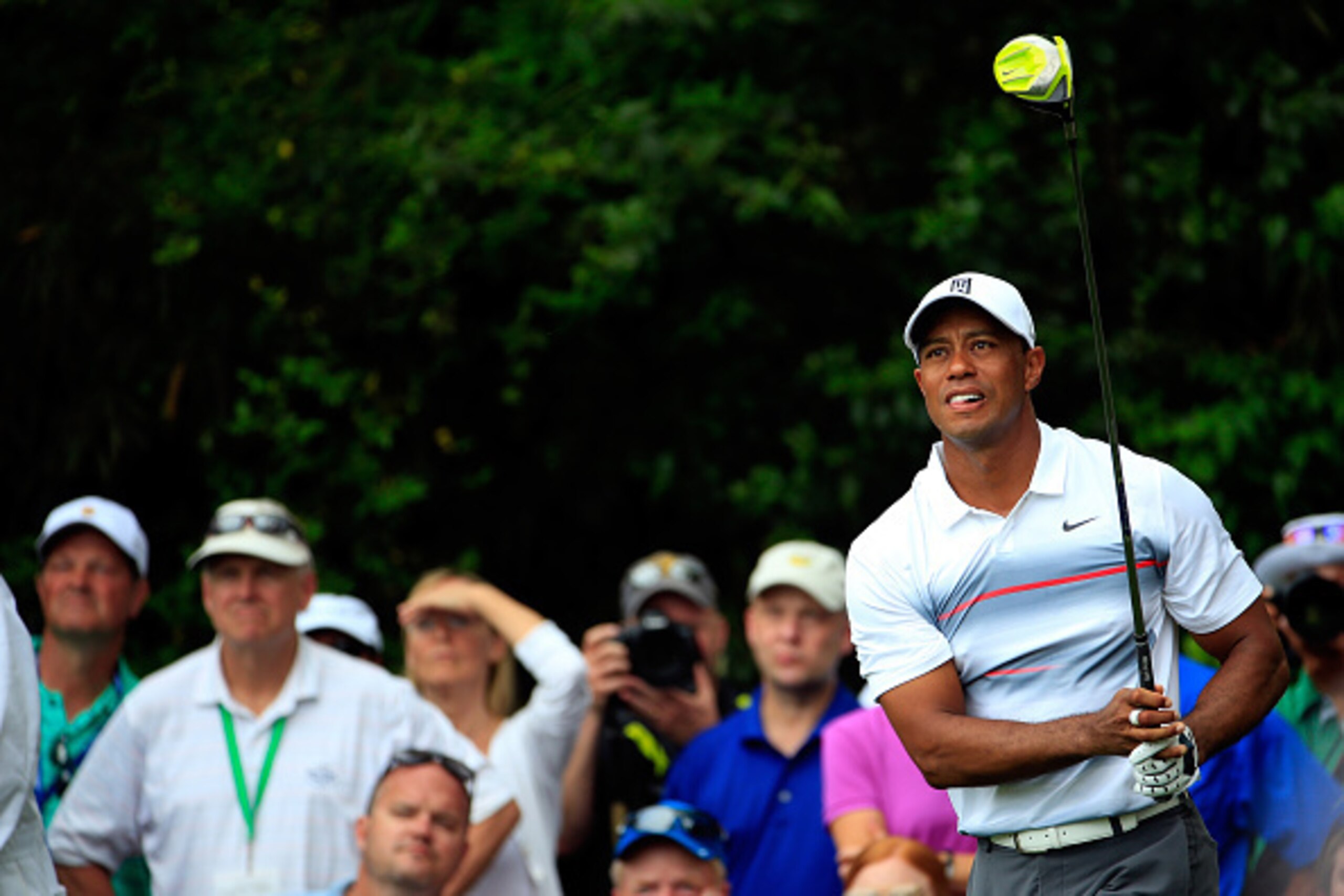 AUGUSTA, GA - APRIL 09:  Tiger Woods of the United States hits a tee shot on the 14th hole as a gallery of patrons look on during the first round of the 2015 Masters Tournament at Augusta National Golf Club on April 9, 2015 in Augusta, Georgia.  (Photo by