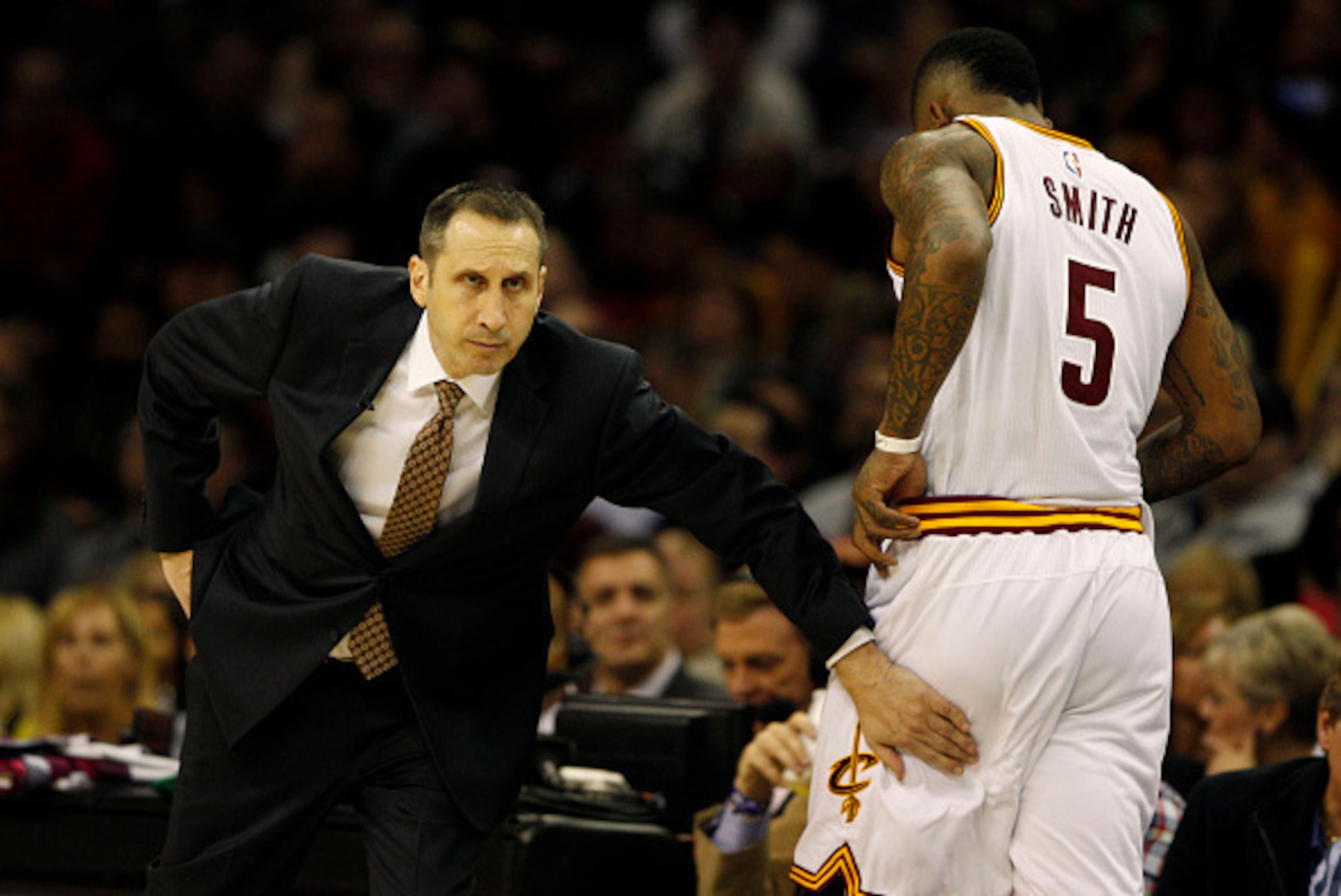 CLEVELAND, OH - JANUARY 7:  J.R. Smith #5 of the Cleveland Cavaliers gets congratulations from Cavaliers Head Coach Dave Blatt as he returns to the bench against the Houston Rockets during the second half of their game on January 7, 2015 at Quicken Loans 