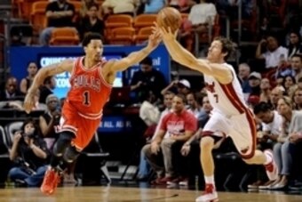 Apr 9, 2015; Miami, FL, USA; Chicago Bulls guard Derrick Rose (1) and Miami Heat guard Goran Dragic (7) chase a loose ball during the first half at American Airlines Arena. Mandatory Credit: Steve Mitchell-USA TODAY Sports