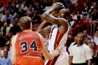 Apr 9, 2015; Miami, FL, USA; Miami Heat forward Luol Deng (9) is pressured by Chicago Bulls forward Mike Dunleavy (34) during the second half at American Airlines Arena. Mandatory Credit: Steve Mitchell-USA TODAY Sports