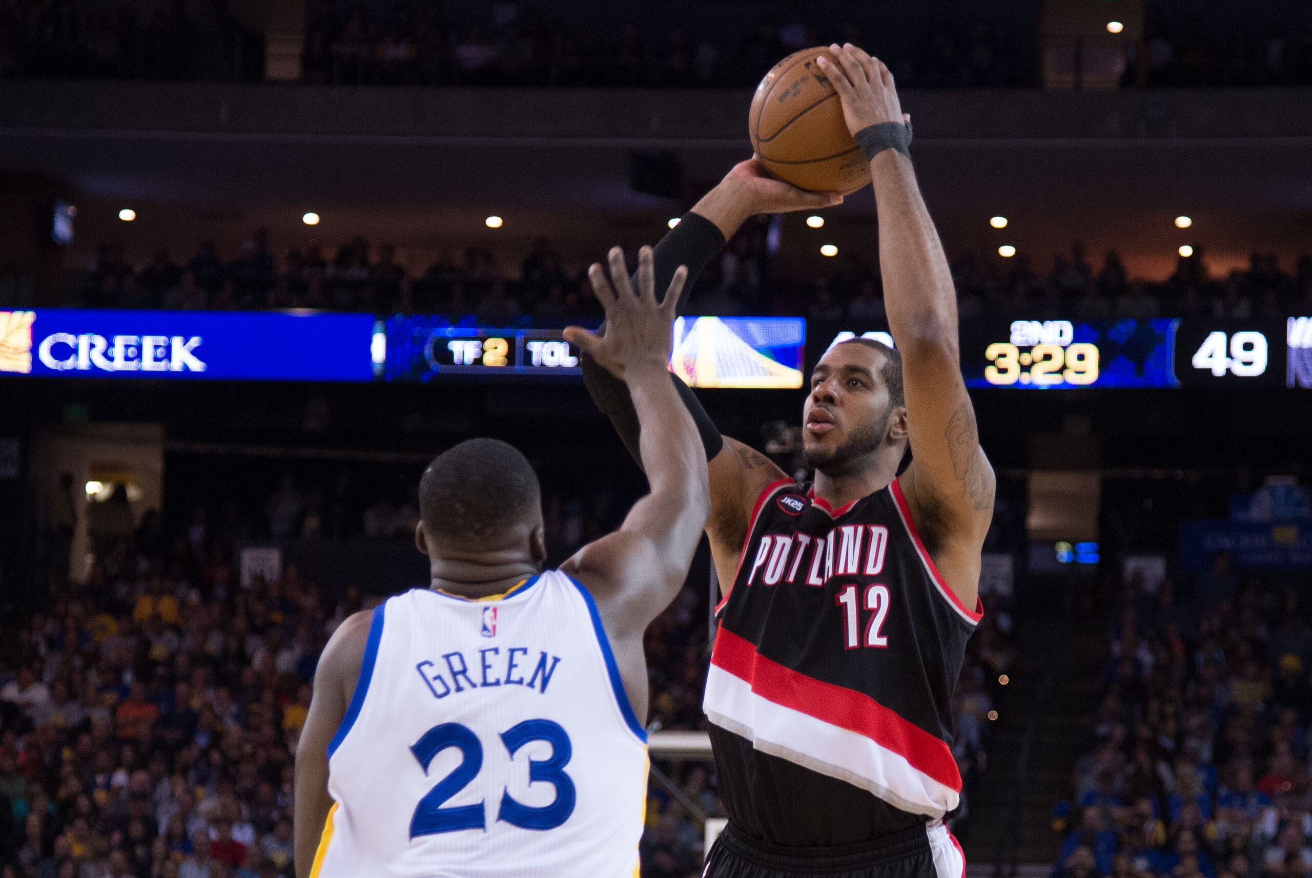 April 9, 2015; Oakland, CA, USA; Portland Trail Blazers forward LaMarcus Aldridge (12) shoots the basketball against Golden State Warriors forward Draymond Green (23) during the second quarter at Oracle Arena. Mandatory Credit: Kyle Terada-USA TODAY Sport