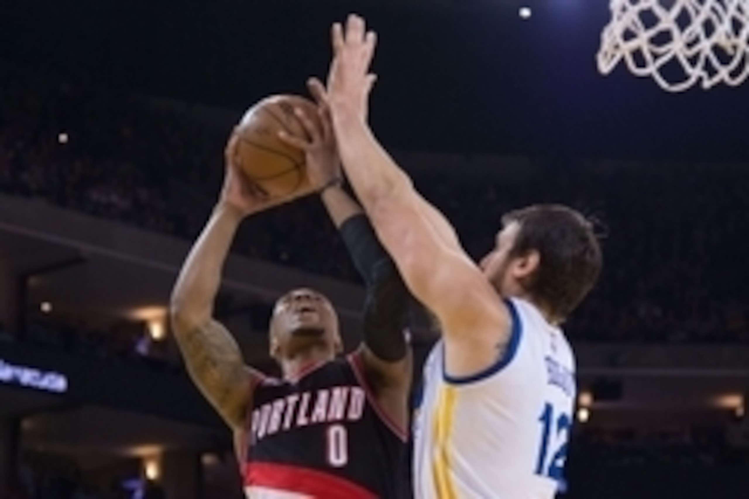 April 9, 2015; Oakland, CA, USA; Portland Trail Blazers guard Damian Lillard (0) shoots the basketball against Golden State Warriors center Andrew Bogut (12) during the second quarter at Oracle Arena. Mandatory Credit: Kyle Terada-USA TODAY Sports