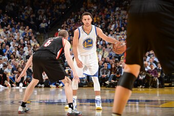 OAKLAND, CA -APRIL 9: Stephen Curry #30 of the Golden State Warriors dribbles against Steve Blake #5 of the Portland Trail Blazers on April 9, 2015 at Oracle Arena in Oakland, California. NOTE TO USER: User expressly acknowledges and agrees that, by downl