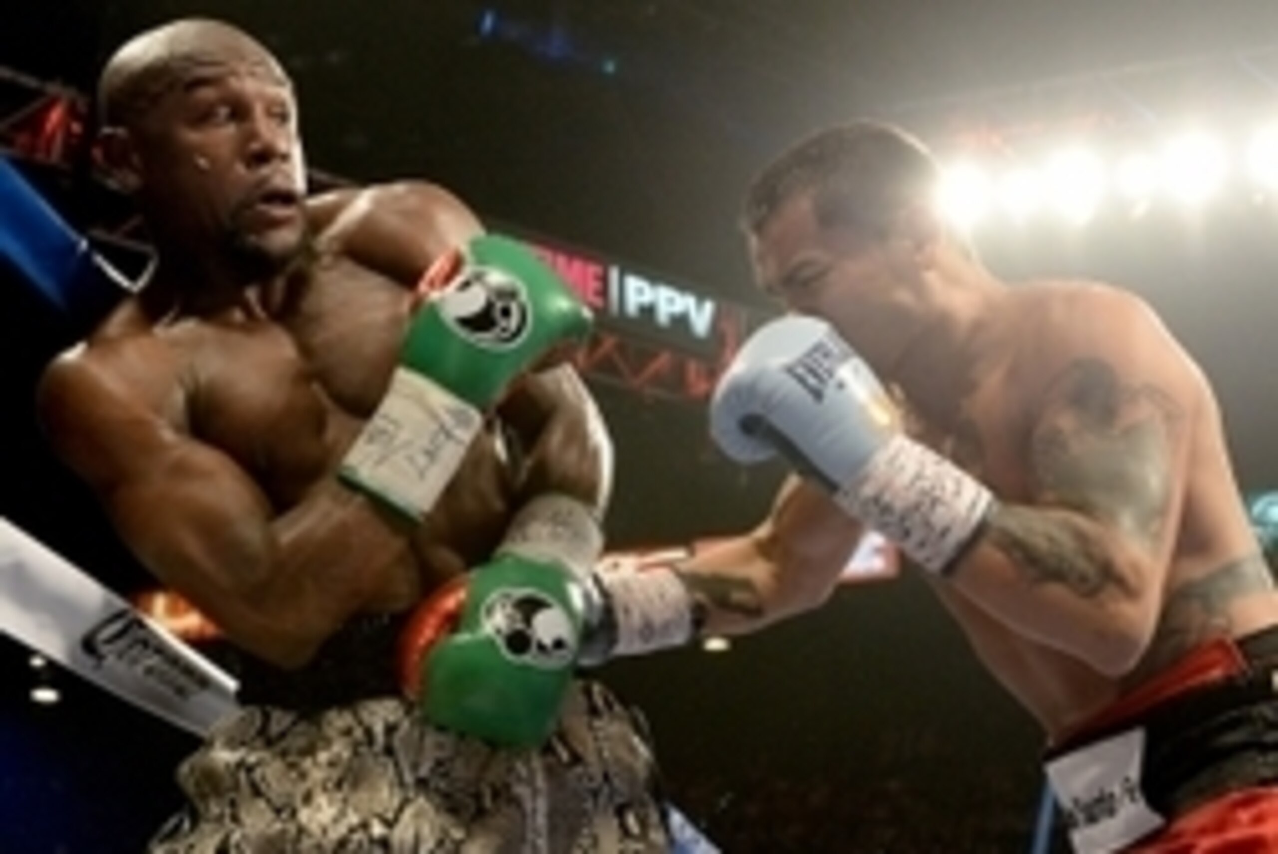 Sep 13, 2014; Las Vegas, NV, USA; Floyd Mayweather (green gloves) and Marcos Maidana (blue gloves) during their WBC & WBA Welterweight and WBC Superwelter Weight title fight at the MGM Grand Garden Arena. Mandatory Credit: Jayne Kamin-Oncea-USA TODAY Spor