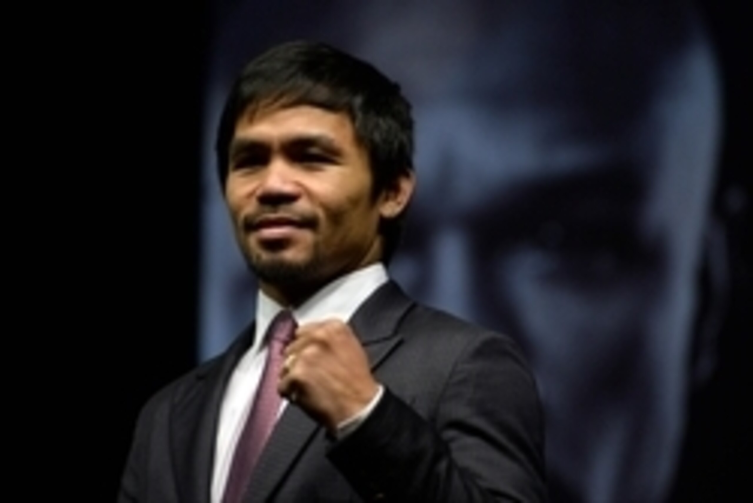 Mar 11, 2015; Los Angeles, CA, USA; Manny Pacquiao poses for photographers during a press conference to announce their fight on May 2, 2015 at the Nokia Theater in Los Angeles. Mandatory Credit: Robert Hanashiro-USA TODAY Sports