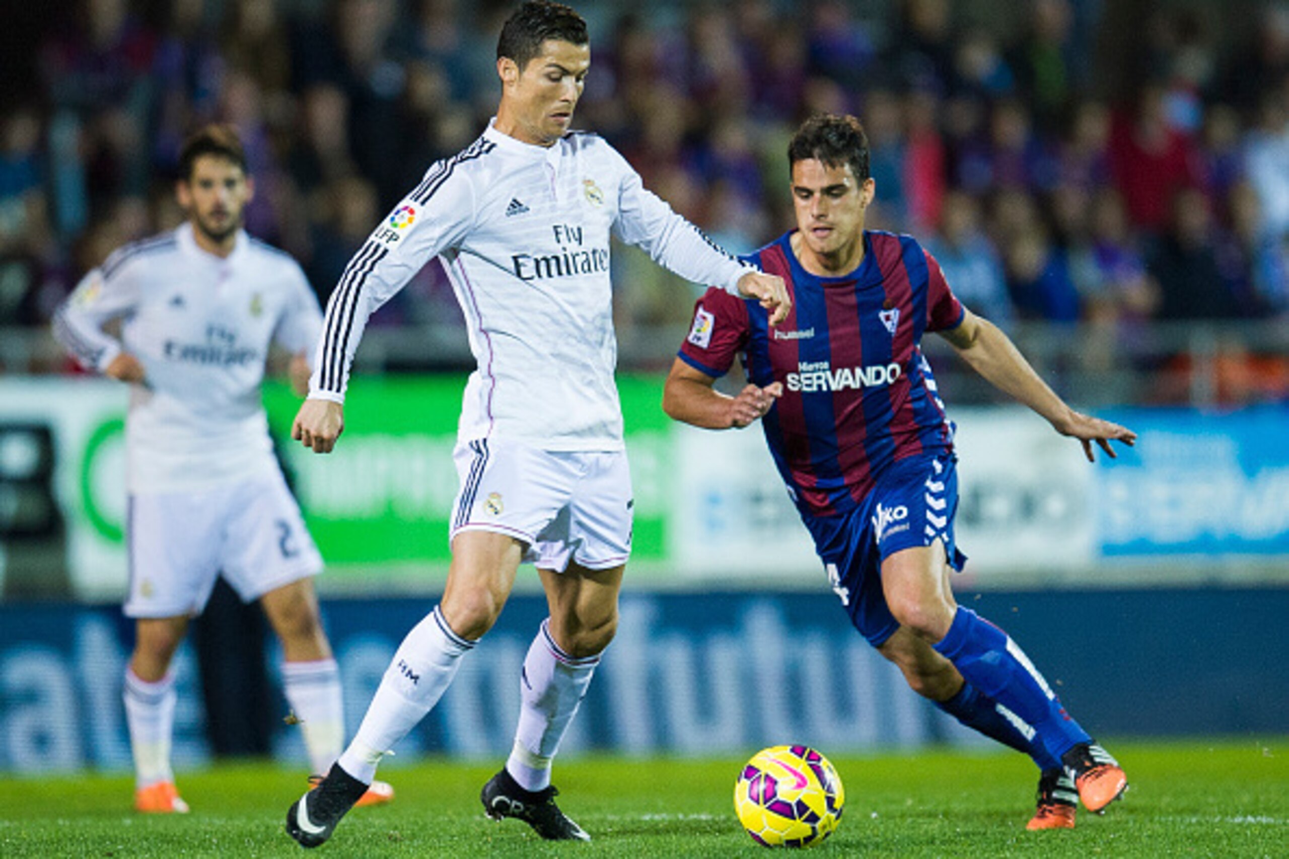 EIBAR, SPAIN - NOVEMBER 22: Cristiano Ronaldo of Real Madrid duels for the ball with Daniel Garcia of SD Eibar during the La Liga match between SD Eibar and Real Madrid at Ipurua Municipal Stadium on November 22, 2014 in Eibar, Spain. (Photo by Juan Manue