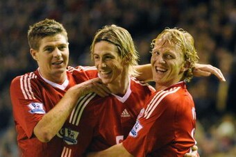 LIVERPOOL, ENGLAND - DECEMBER 13:  Dirk Kuyt (R) of Liverpool celebrates scoring the opening goal with team mates Steven Gerrard (L) and Fernando Torres during the Barclays Premier League match between Liverpool and Arsenal at Anfield on December 13, 2009