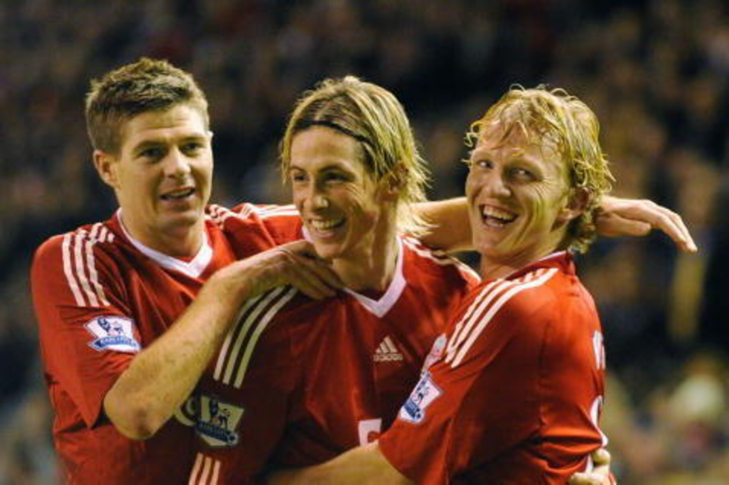 LIVERPOOL, ENGLAND - DECEMBER 13:  Dirk Kuyt (R) of Liverpool celebrates scoring the opening goal with team mates Steven Gerrard (L) and Fernando Torres during the Barclays Premier League match between Liverpool and Arsenal at Anfield on December 13, 2009