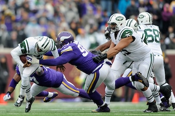 MINNEAPOLIS, MN - DECEMBER 7: Geno Smith #7 of the New York Jets avoids a sack by Everson Griffen #97 and Tom Johnson #92 of the Minnesota Vikings during the second quarter of the game on December 7, 2014 at TCF Bank Stadium in Minneapolis, Minnesota. (Ph