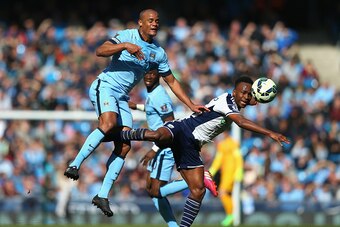 MANCHESTER, ENGLAND - MARCH 21:  Vincent Kompany of Manchester City and Saido Berahino of West Brom batlte for the ball during the Barclays Premier League match between Manchester City and West Bromwich Albion at Etihad Stadium on March 21, 2015 in Manche