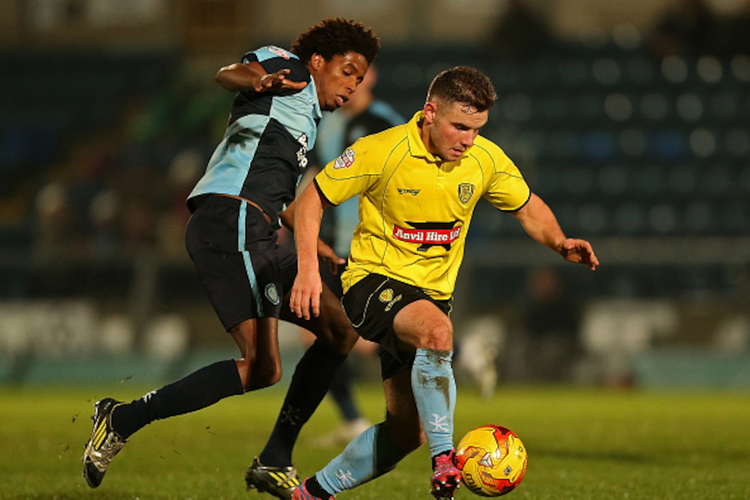 HIGH WYCOMBE, ENGLAND - NOVEMBER 17: Alex MacDonald of Burton holds off pressure from Sido Jombati of Wycombe during the Sky Bet League Two match between Wycombe Wanderers and Burton Albion at Adams Park on November 17, 2014 in High Wycombe, England. (P HIGH WYCOMBE, ENGLAND - NOVEMBER 17: Alex MacDonald of Burton holds off pressure from Sido Jombati of Wycombe during the Sky Bet League Two match between Wycombe Wanderers and Burton Albion at Adams Park on November 17, 2014 in High Wycombe, England. (P