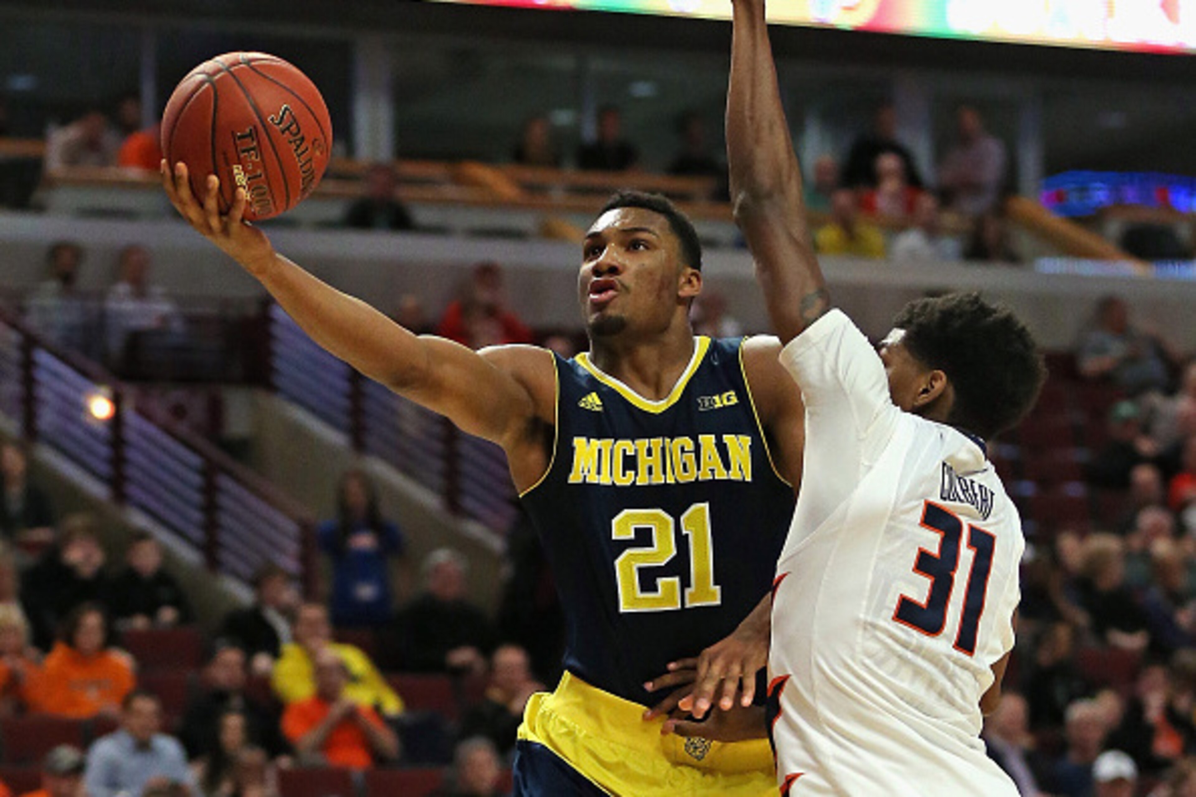 CHICAGO, IL - MARCH 12: Zak Irvin #21 of the Michigan Wolverines puts up a shot against Austin Colbert #31 of the Illinois Fighting Illini during the second round of the 2015 Big Ten Men's Basketball Tournament at the United Center on March 12, 2015 in Ch