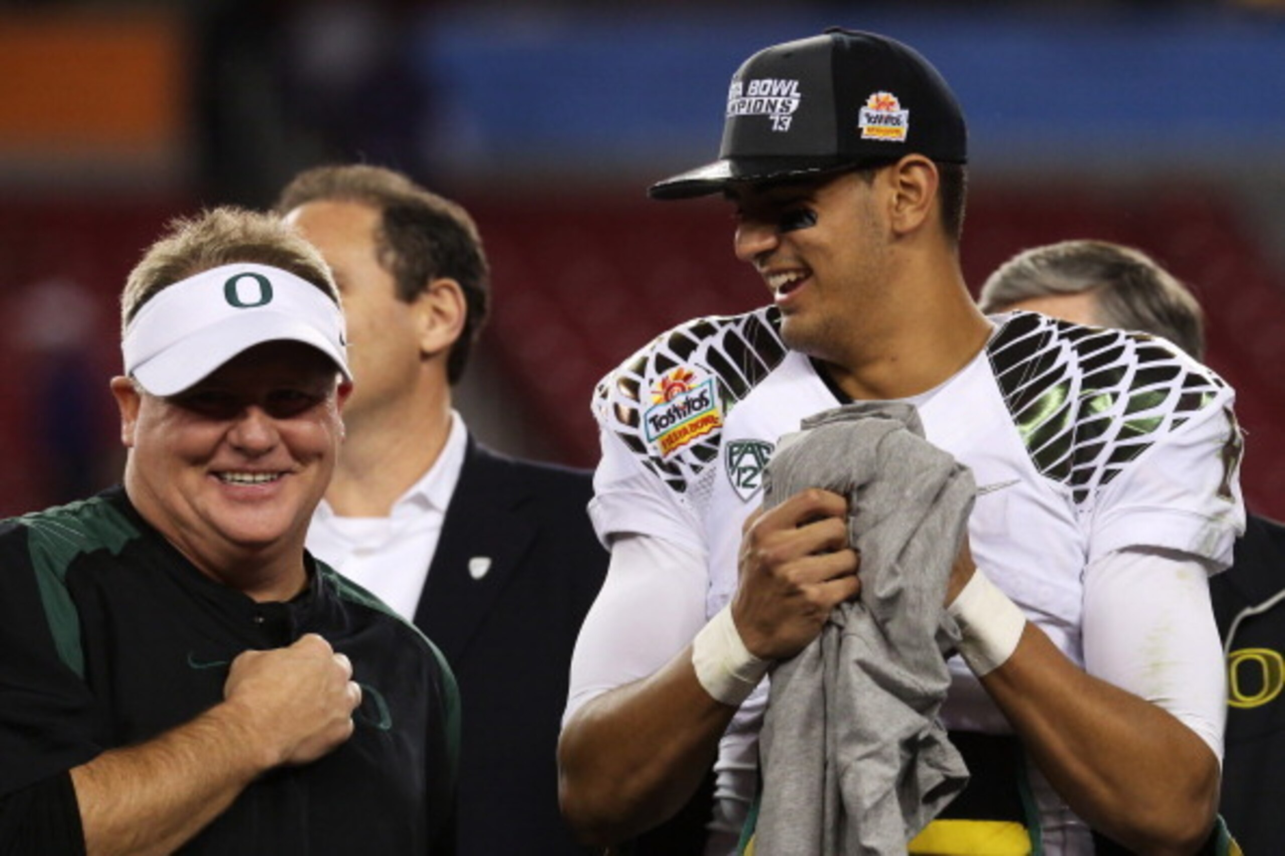 GLENDALE, AZ - JANUARY 03: Head coach Chip Kelly celebrates with Marcus Mariota #8 of the Oregon Ducks after their 35 to 17 win over the Kansas State Wildcats in the Tostitos Fiesta Bowl at University of Phoenix Stadium on January 3, 2013 in Glendale, Ar GLENDALE, AZ - JANUARY 03: Head coach Chip Kelly celebrates with Marcus Mariota #8 of the Oregon Ducks after their 35 to 17 win over the Kansas State Wildcats in the Tostitos Fiesta Bowl at University of Phoenix Stadium on January 3, 2013 in Glendale, Ar