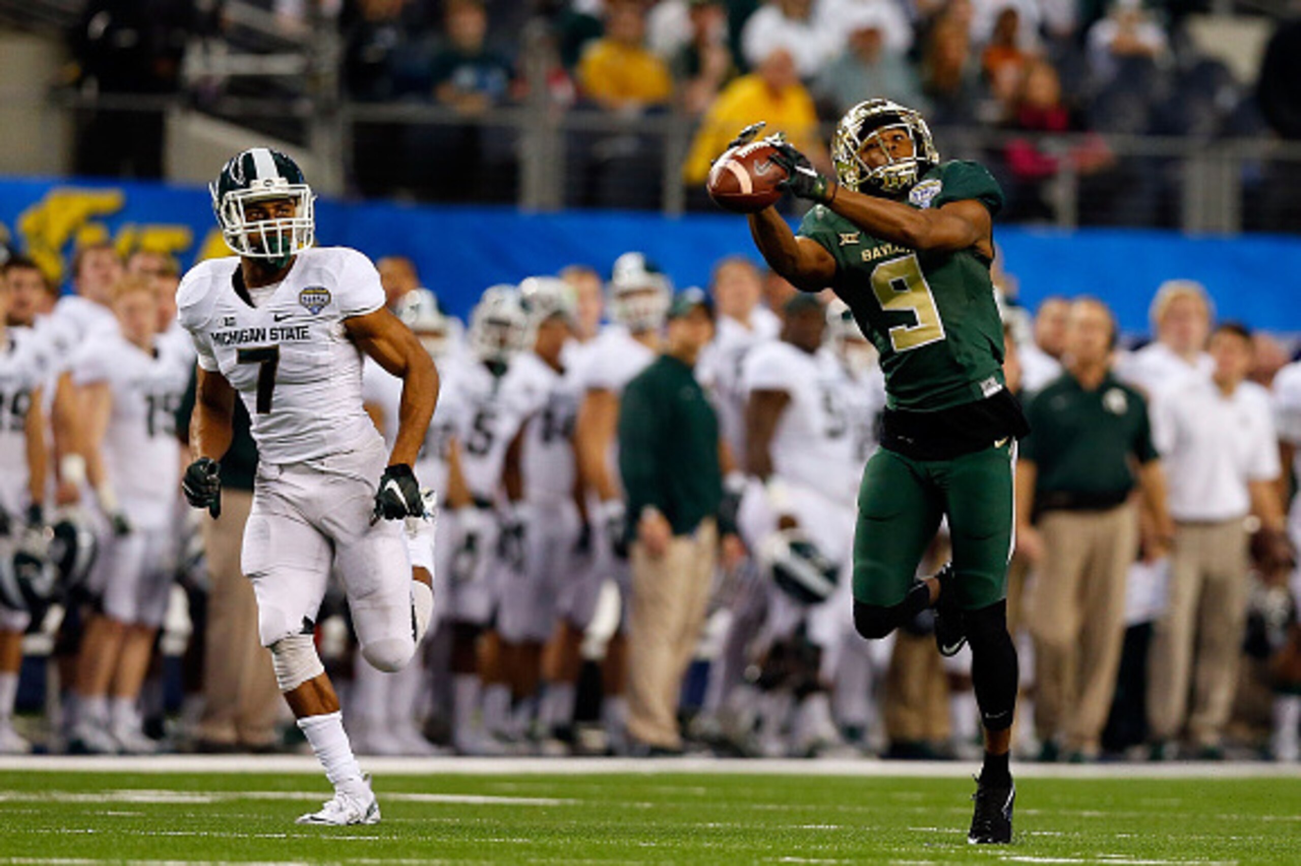 ARLINGTON, TX - JANUARY 01:  KD Cannon #9 of the Baylor Bears makes the catch and runs for a touchdown as Demetrious Cox #7 of the Michigan State Spartans defends during the second half of the Goodyear Cotton Bowl Classic at AT&T Stadium on January 1, 201