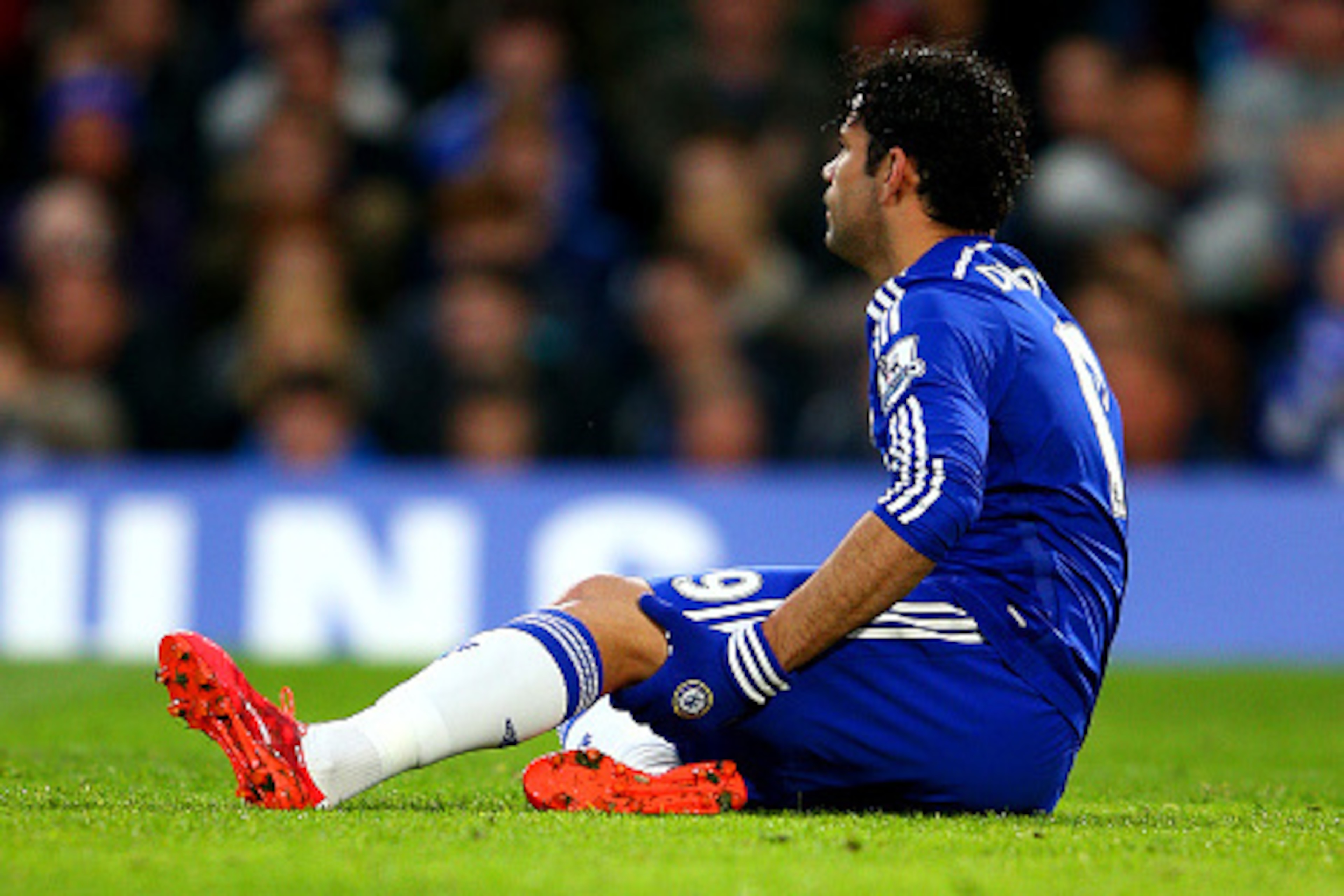 LONDON, ENGLAND - APRIL 04:  Diego Costa of Chelsea holds his leg as he sits on the turf before leaving the pitch injured during the Barclays Premier League match between Chelsea and Stoke City at Stamford Bridge on April 4, 2015 in London, England.  (Pho
