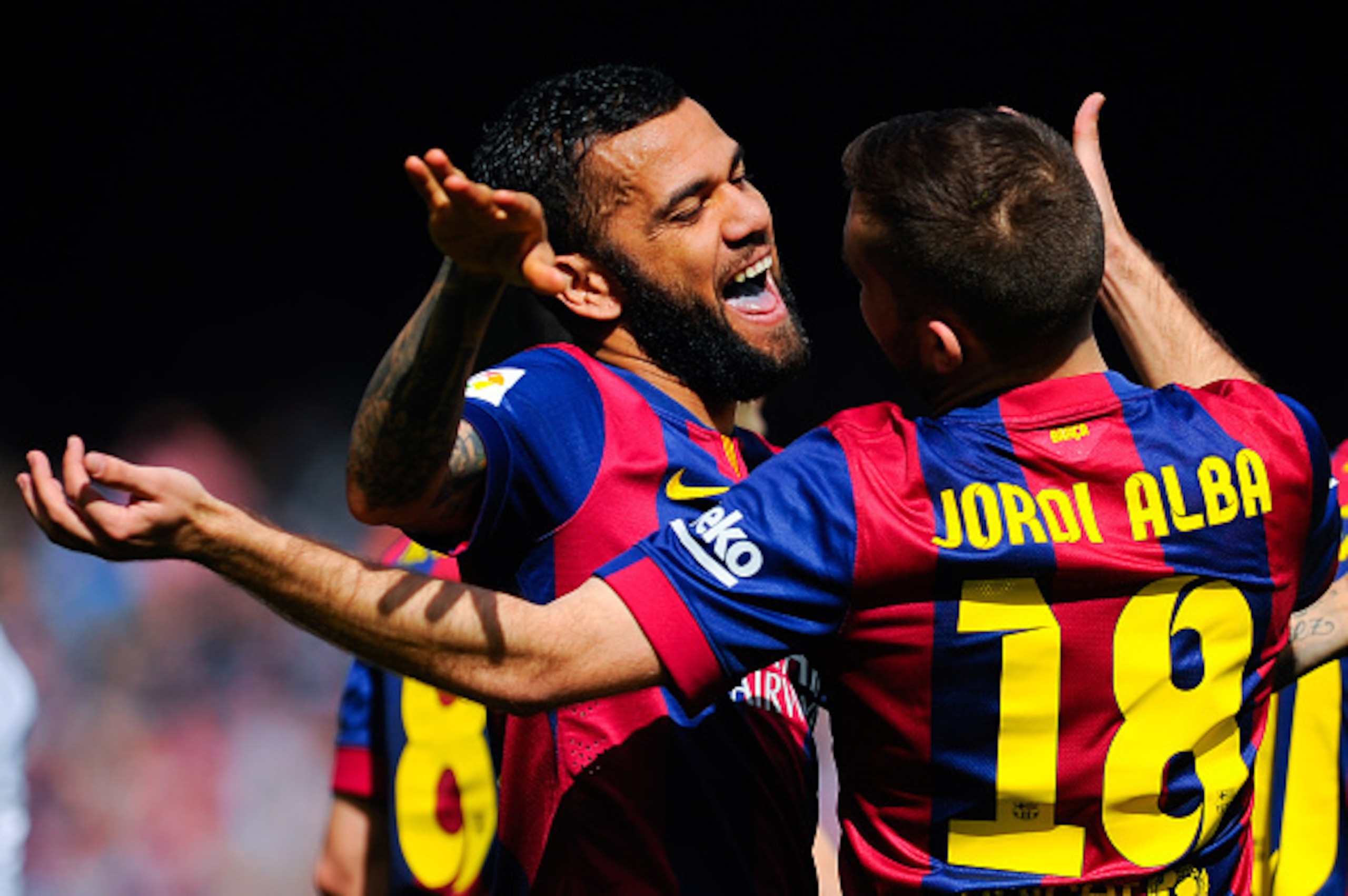 BARCELONA, SPAIN - MARCH 08: Dani Alves of FC Barcelona celebrates with his teammate Jordi Alba of FC Barcelona after Gerard Pique scored his team's second goal during the La Liga match between FC Barcelona and Rayo Vallecano de Madrid at Camp Nou on Mar BARCELONA, SPAIN - MARCH 08: Dani Alves of FC Barcelona celebrates with his teammate Jordi Alba of FC Barcelona after Gerard Pique scored his team's second goal during the La Liga match between FC Barcelona and Rayo Vallecano de Madrid at Camp Nou on Mar