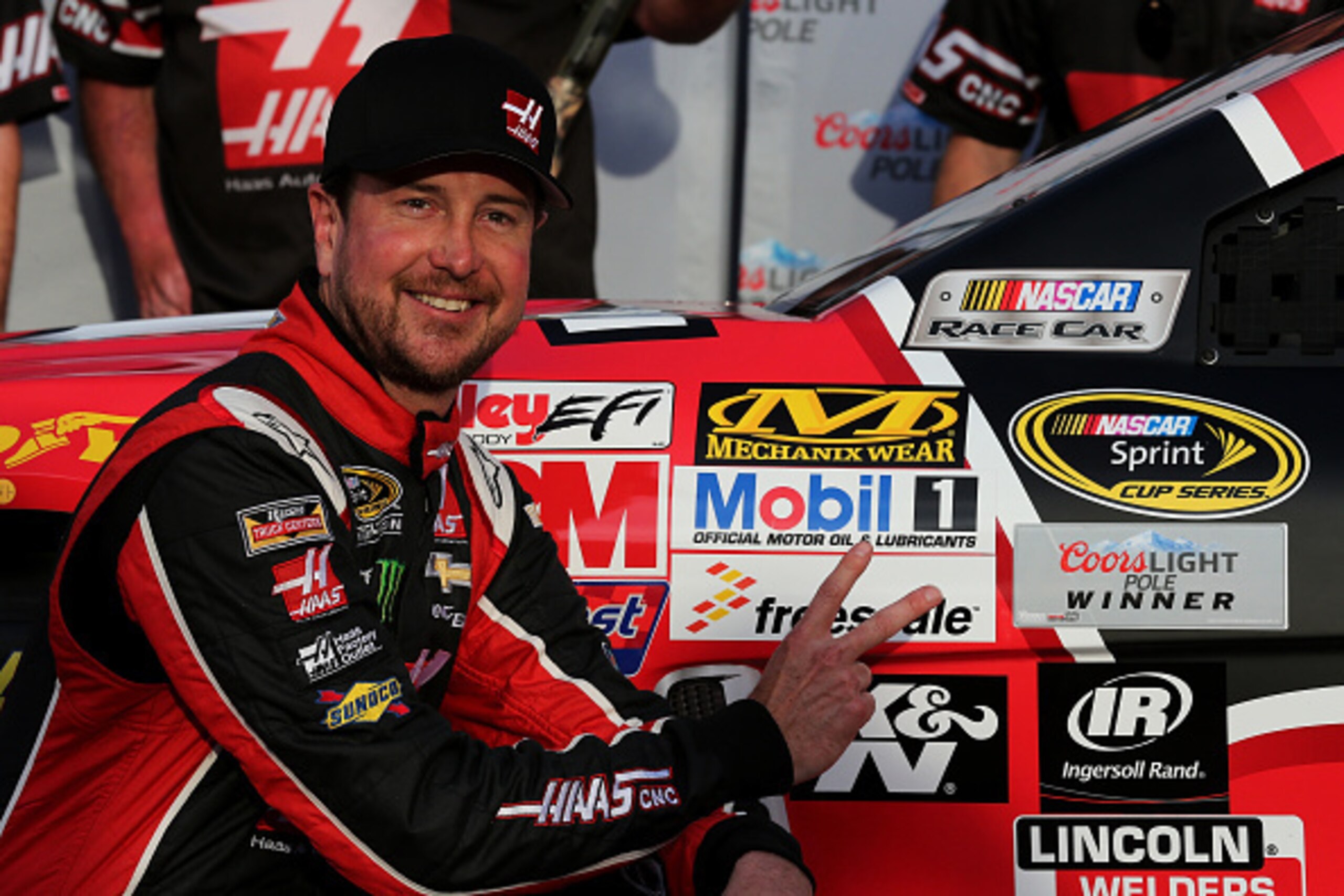 FORT WORTH, TX - APRIL 10:  Kurt Busch, driver of the #41 Haas Automation Chevrolet, poses with the Coors Light Pole Award decal after qualifying for the pole for the NASCAR Sprint Cup Series Duck Commander 500 at Texas Motor Speedway on April 10, 2015 in