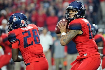 Dec 31, 2014; Glendale, AZ, USA; Arizona Wildcats quarterback Anu Solomon (12) prepares to pass during the first quarter against the Boise State Broncos in the 2014 Fiesta Bowl at Phoenix Stadium. The Broncos won 38-30. Mandatory Credit: Casey Sapio-USA T