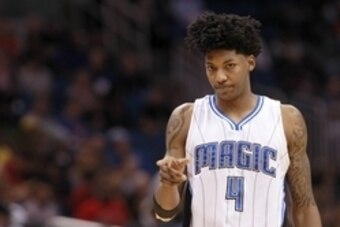 Apr 10, 2015; Orlando, FL, USA; Orlando Magic guard Elfrid Payton (4) points from the court against the Toronto Raptors during the second quarter at Amway Center. Mandatory Credit: Kim Klement-USA TODAY Sports