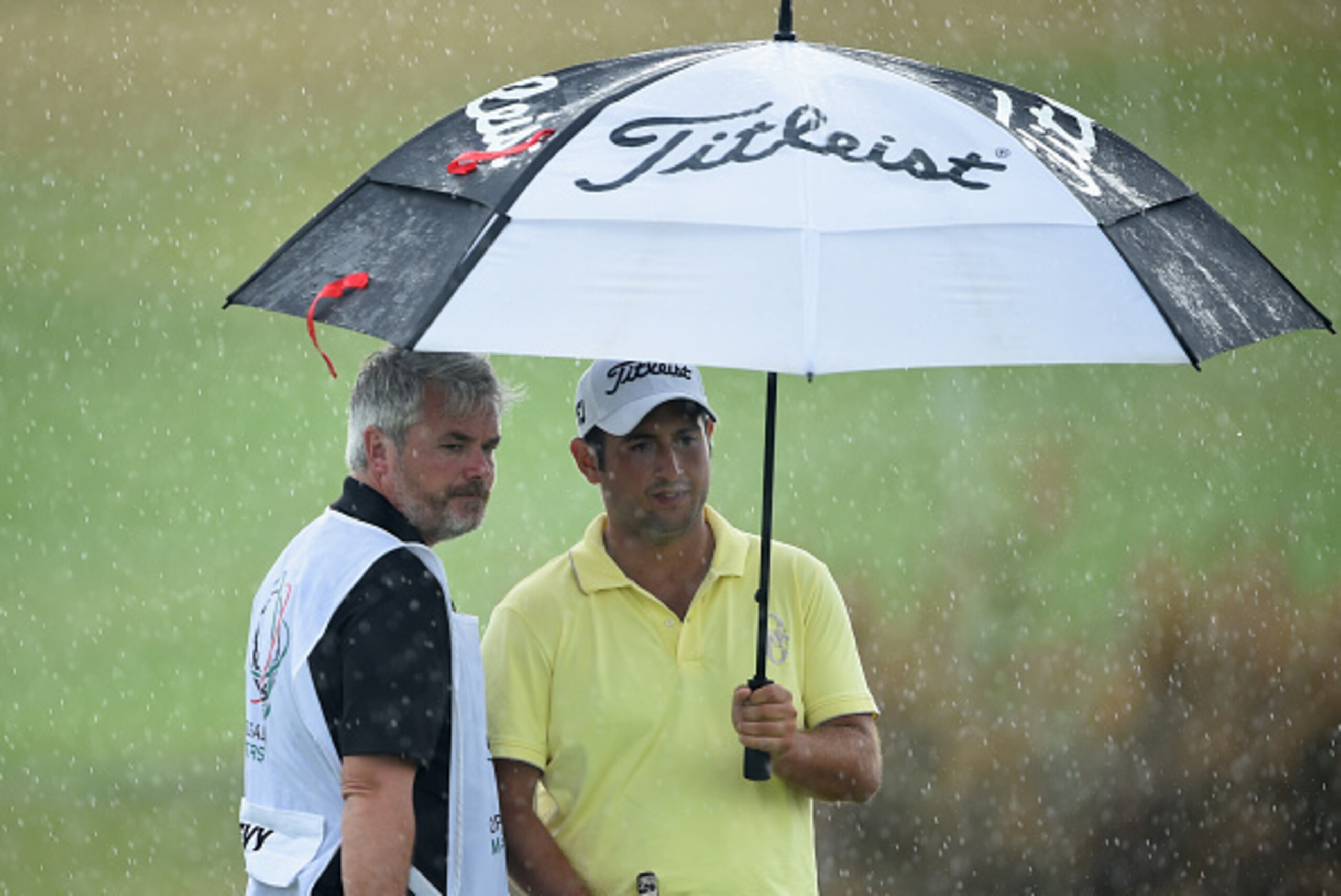 ALBUFEIRA, PORTUGAL - OCTOBER 09:  Alexander Levy of France shelters from the rain during the first round of the Portugal Masters at Oceanico Victoria Golf Club on October 9, 2014 in Albufeira, Portugal.  (Photo by Stuart Franklin/Getty Images)