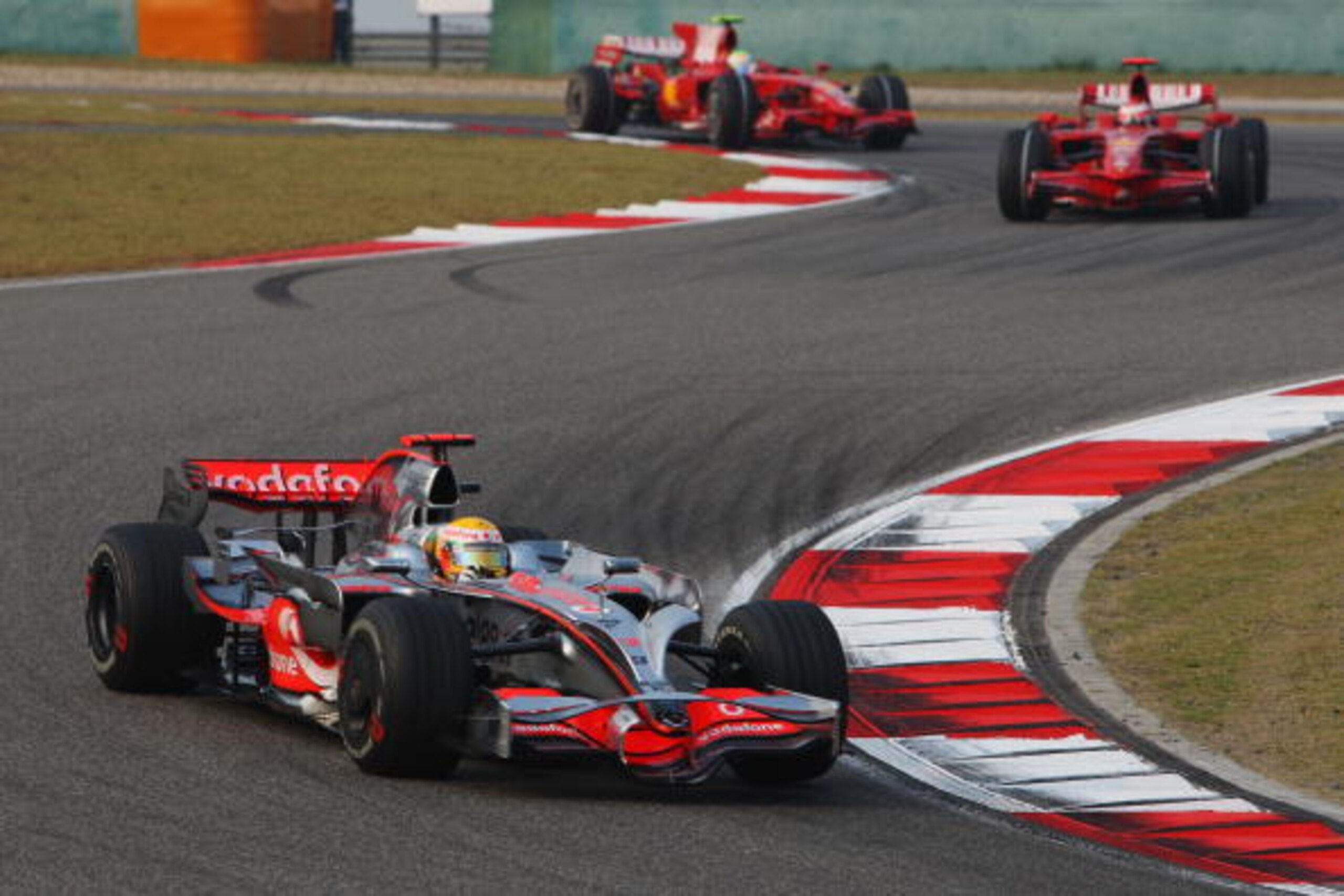 SHANGHAI, CHINA - OCTOBER 19:  Lewis Hamilton of Great Britain and McLaren Mercedes leads from Kimi Raikkonen of Finland and Ferrari and Felipe Massa of Brazil and Ferrari at the start of the Chinese Formula One Grand Prix at the Shanghai International Ci