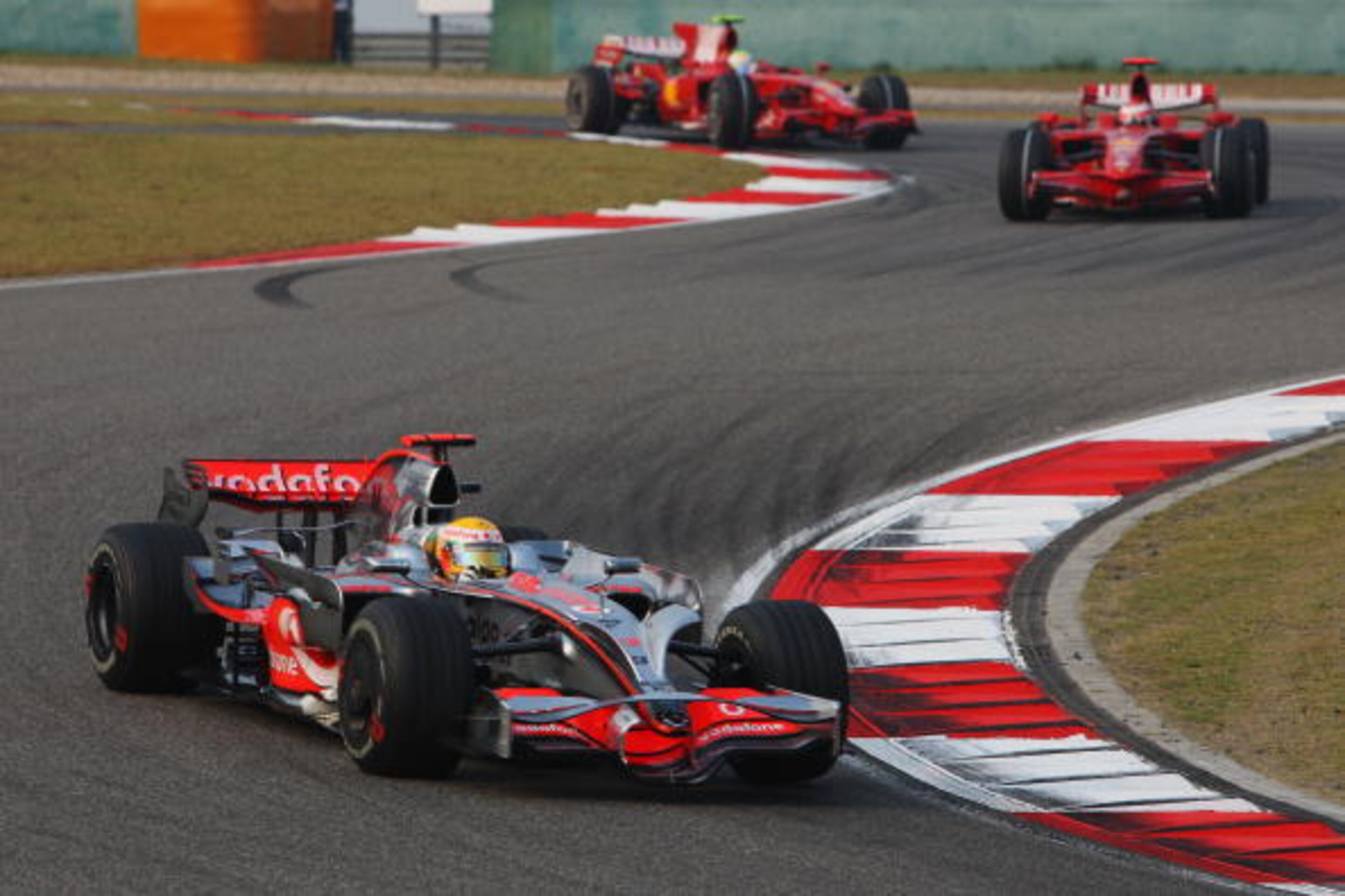 SHANGHAI, CHINA - OCTOBER 19:  Lewis Hamilton of Great Britain and McLaren Mercedes leads from Kimi Raikkonen of Finland and Ferrari and Felipe Massa of Brazil and Ferrari at the start of the Chinese Formula One Grand Prix at the Shanghai International Ci