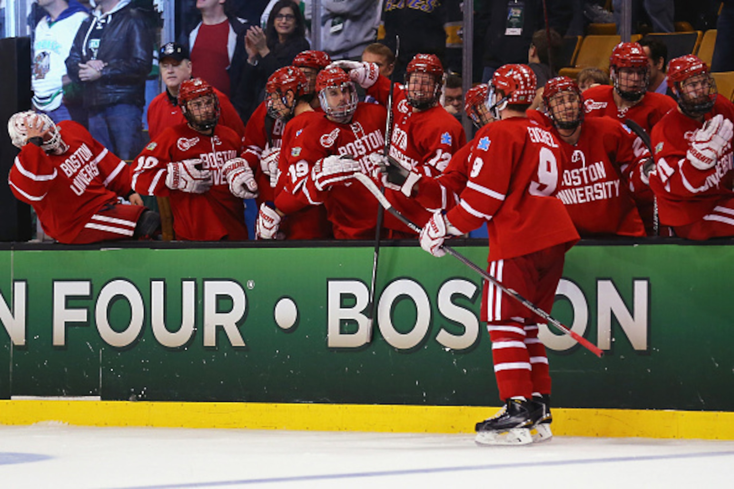 BOSTON, MA - APRIL 09: Jack Eichel #9 of the Boston University Terriers is congratulated by teammates after scoring against North Dakota during the third period of the 2015 NCAA Division I Men's Hockey Championship semifinals at TD Garden on April 9, 2015