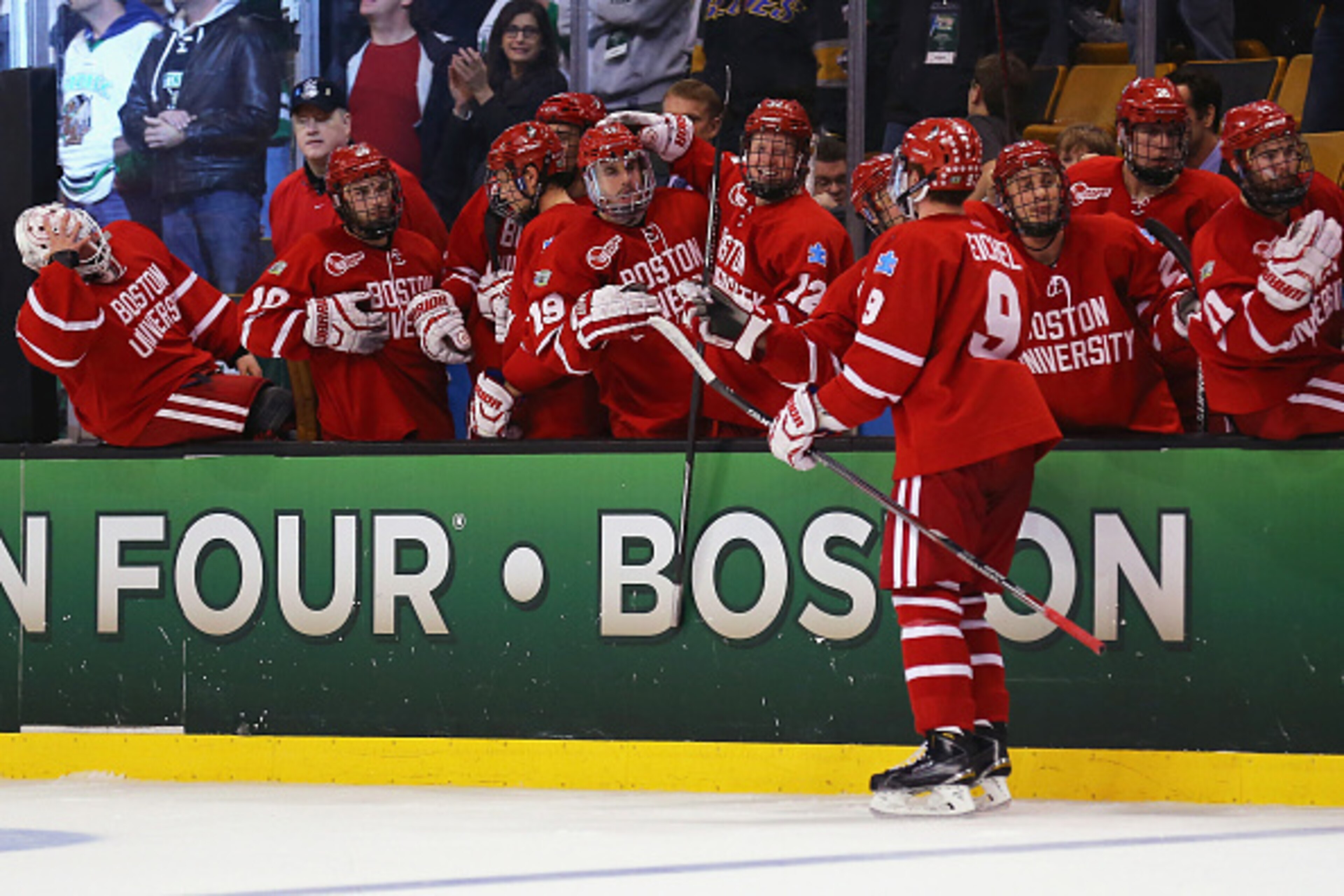 BOSTON, MA - APRIL 09: Jack Eichel #9 of the Boston University Terriers is congratulated by teammates after scoring against North Dakota during the third period of the 2015 NCAA Division I Men's Hockey Championship semifinals at TD Garden on April 9, 2015