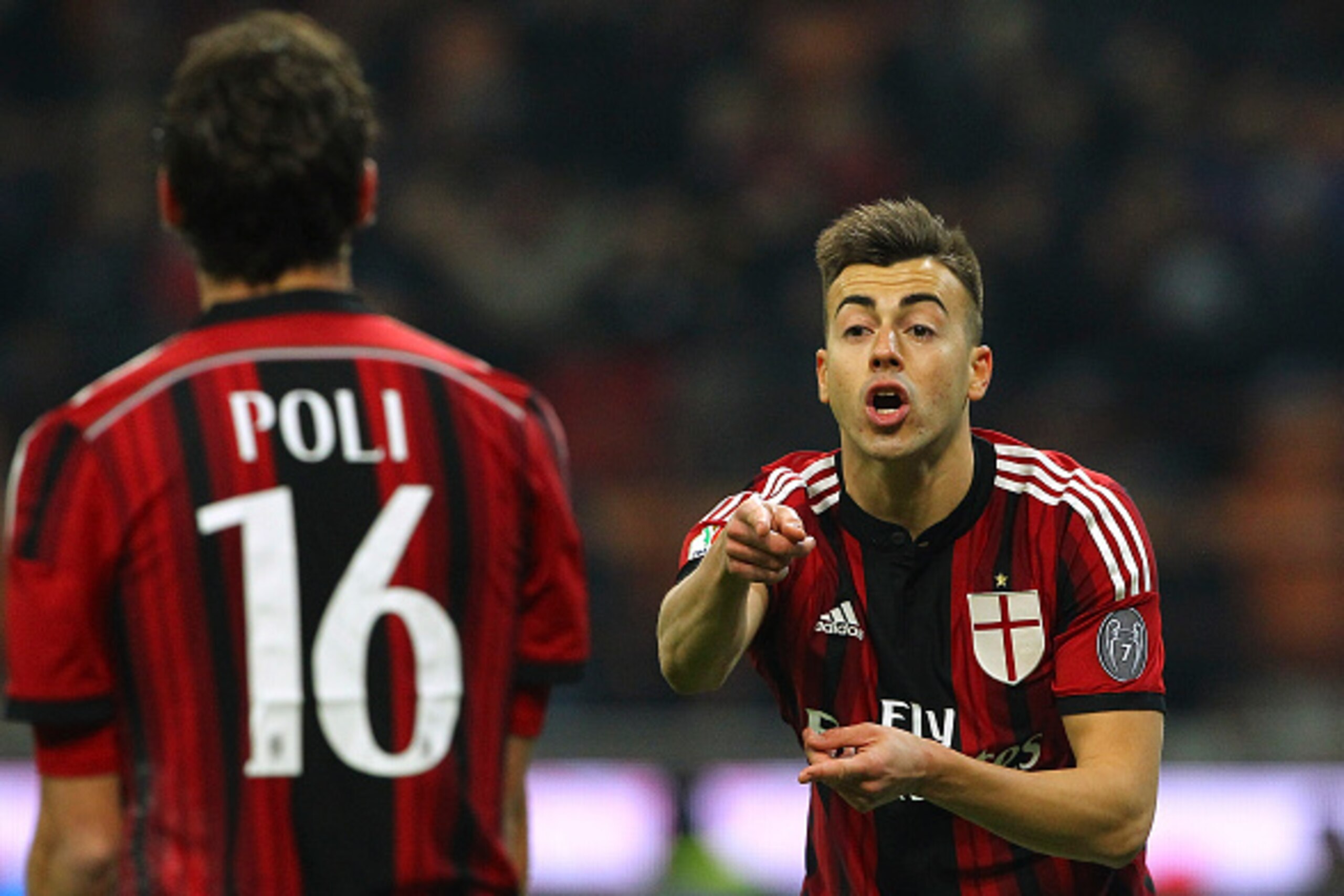 MILAN, ITALY - JANUARY 13:  Stephan El Shaarawy (R) of AC Milan speaks to his team-mate Andrea Poli (L) during the TIM Cup match between AC Milan and US Sassuolo Calcio at Stadio Giuseppe Meazza on January 13, 2015 in Milan, Italy.  (Photo by Marco Luzzan
