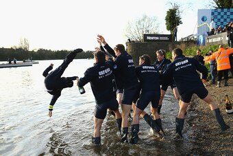 LONDON, ENGLAND - APRIL 11:  Oxford Men throw Cox Will Hakim into the Thames after winning the BNY Mellon Oxford v Cambridge University Boat Race 2015 on April 11, 2015 in London, England.  (Photo by Richard Heathcote/Getty Images)