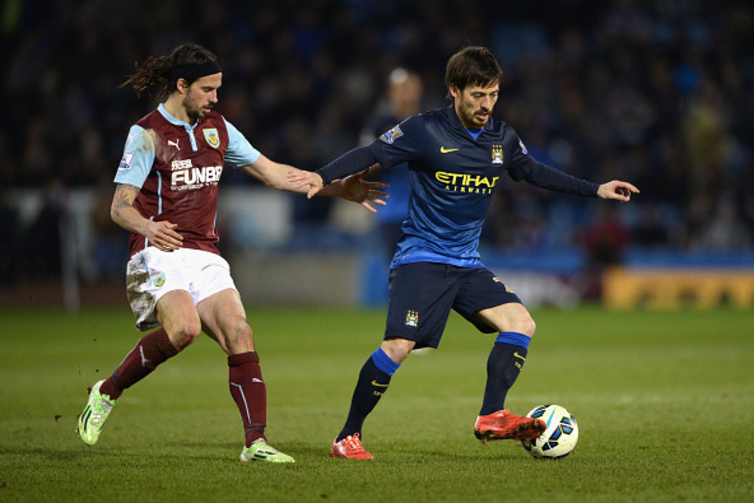 BURNLEY, ENGLAND - MARCH 14:  George Boyd of Burnley marks David Silva of Manchester City during the Barclays Premier League match between Burnley and Manchester City at Turf Moor on March 14, 2015 in Burnley, England.  (Photo by Gareth Copley/Getty Image