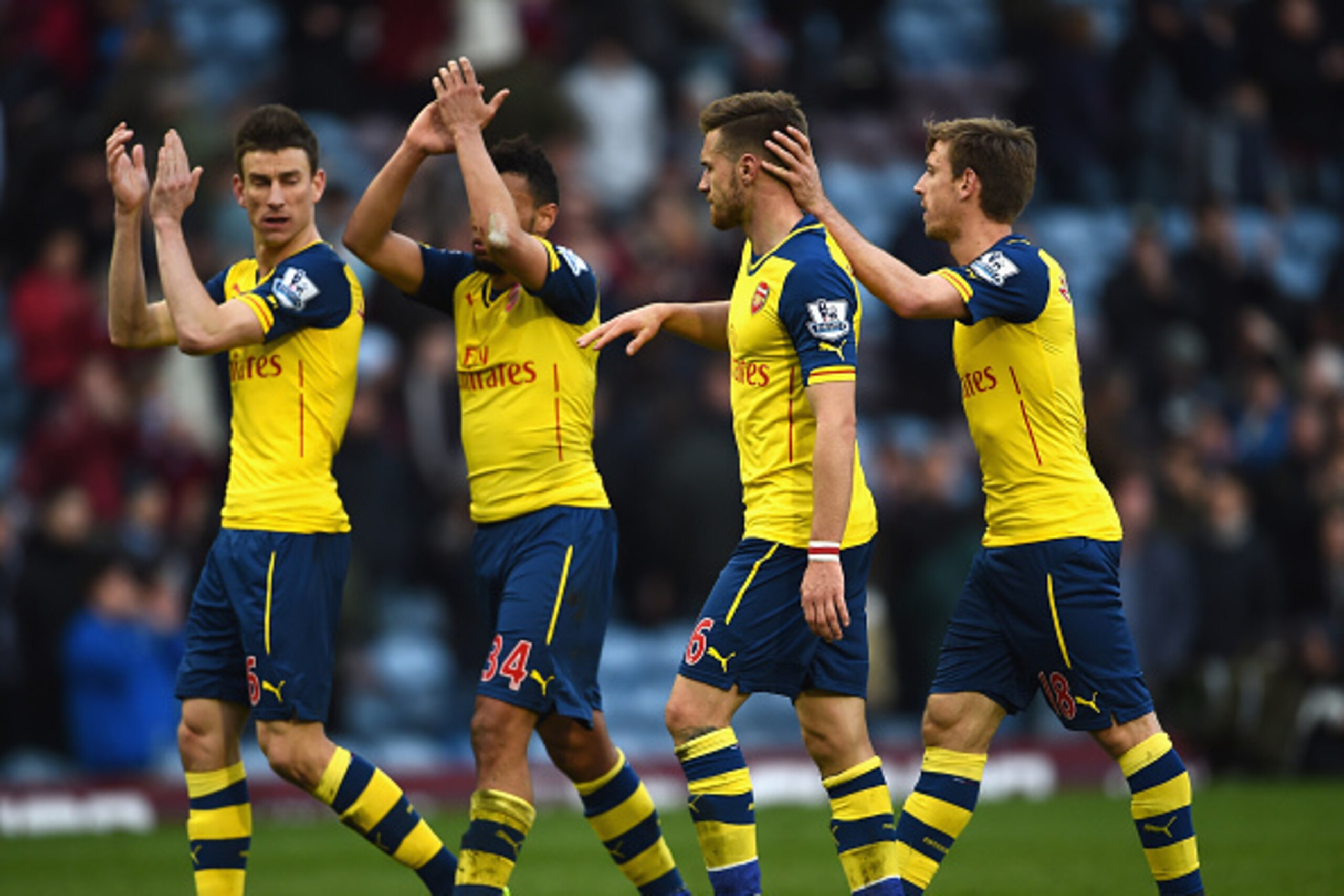 BURNLEY, ENGLAND - APRIL 11: (L-R) Laurent Koscielny, Francis Coquelin, Aaron Ramsey Nacho Monreal of Arsenal applaud the fans after the Barclays Premier League match between Burnley and Arsenal at Turf Moor on April 11, 2015 in Burnley, England. (Photo BURNLEY, ENGLAND - APRIL 11: (L-R) Laurent Koscielny, Francis Coquelin, Aaron Ramsey Nacho Monreal of Arsenal applaud the fans after the Barclays Premier League match between Burnley and Arsenal at Turf Moor on April 11, 2015 in Burnley, England. (Photo