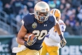 Dec 30, 2014; Nashville, TN, USA; Notre Dame Fighting Irish wide receiver C.J. Prosise (20) carries the ball in the first quarter against the Louisiana State Tigers at LP Field. Notre Dame won 31-28. Mandatory Credit: Matt Cashore-USA TODAY Sports