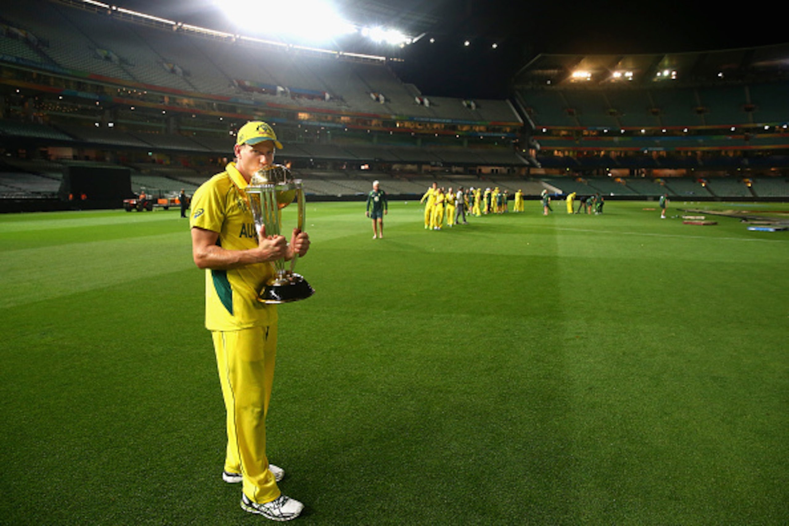 MELBOURNE, AUSTRALIA - MARCH 29:  James Faulkner of Australia celebrates with the trophy on the ground at 2.15am after the 2015 ICC Cricket World Cup final match between Australia and New Zealand at Melbourne Cricket Ground on March 29, 2015 in Melbourne,