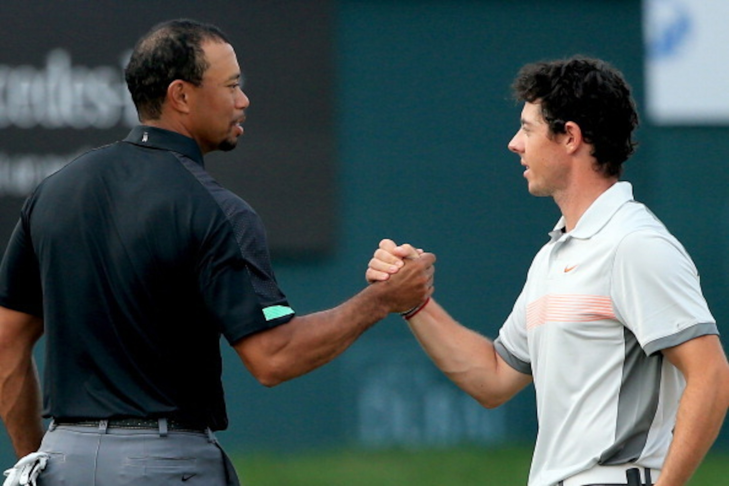 DUBAI, UNITED ARAB EMIRATES - JANUARY 31:  Rory McIlroy of Northern Ireland and Tiger Woods of the USA shake hands on the 18th greenduring the second round of the 2014 Omega Dubai Desert Classic on the Majlis Course at the Emirates Golf Club on January 31