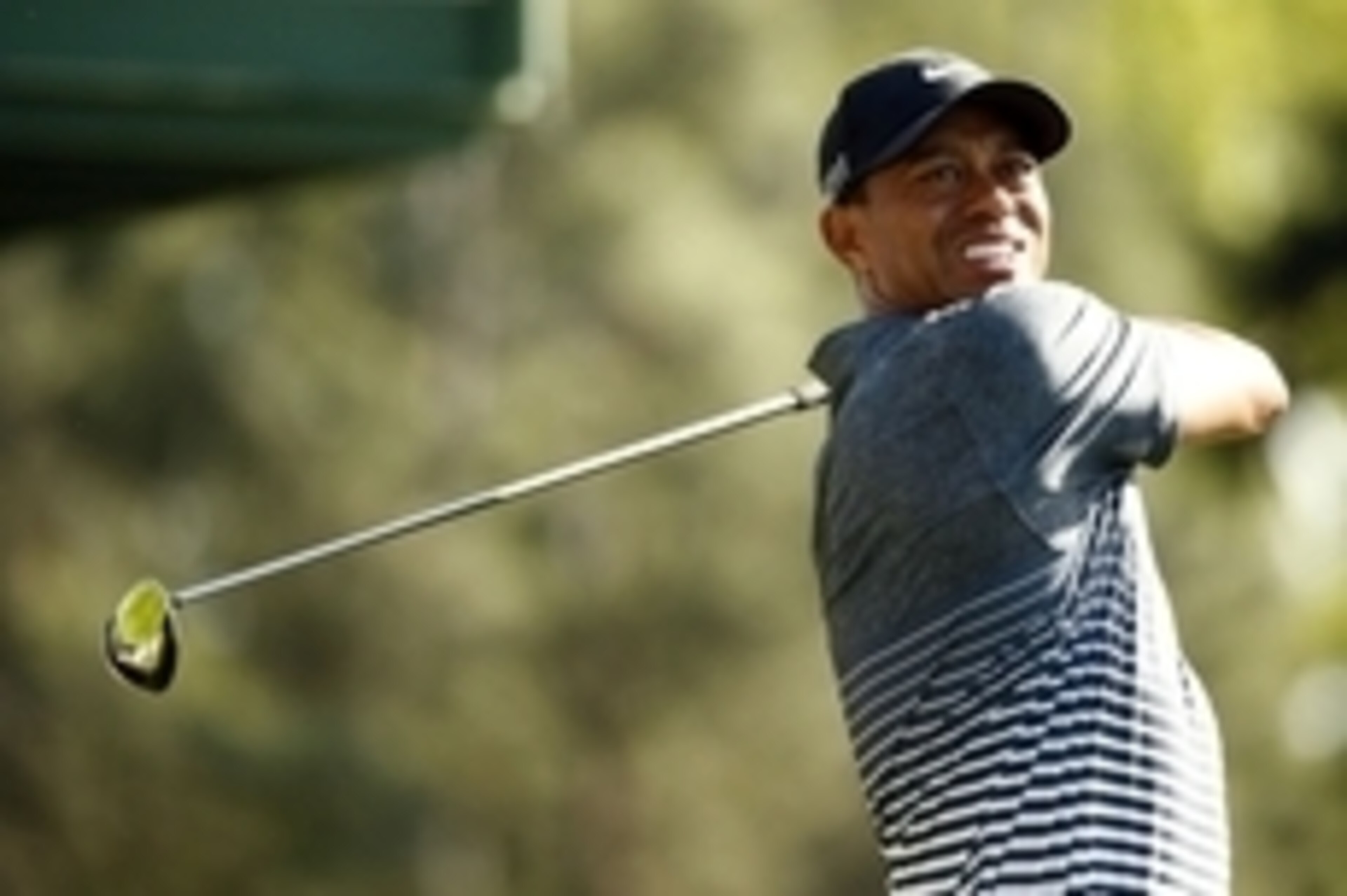 Apr 11, 2015; Augusta, GA, USA; Tiger Woods hits his tee shot on the 18th hole during the third round of The Masters golf tournament at Augusta National Golf Club. Mandatory Credit: Rob Schumacher-USA TODAY Sports