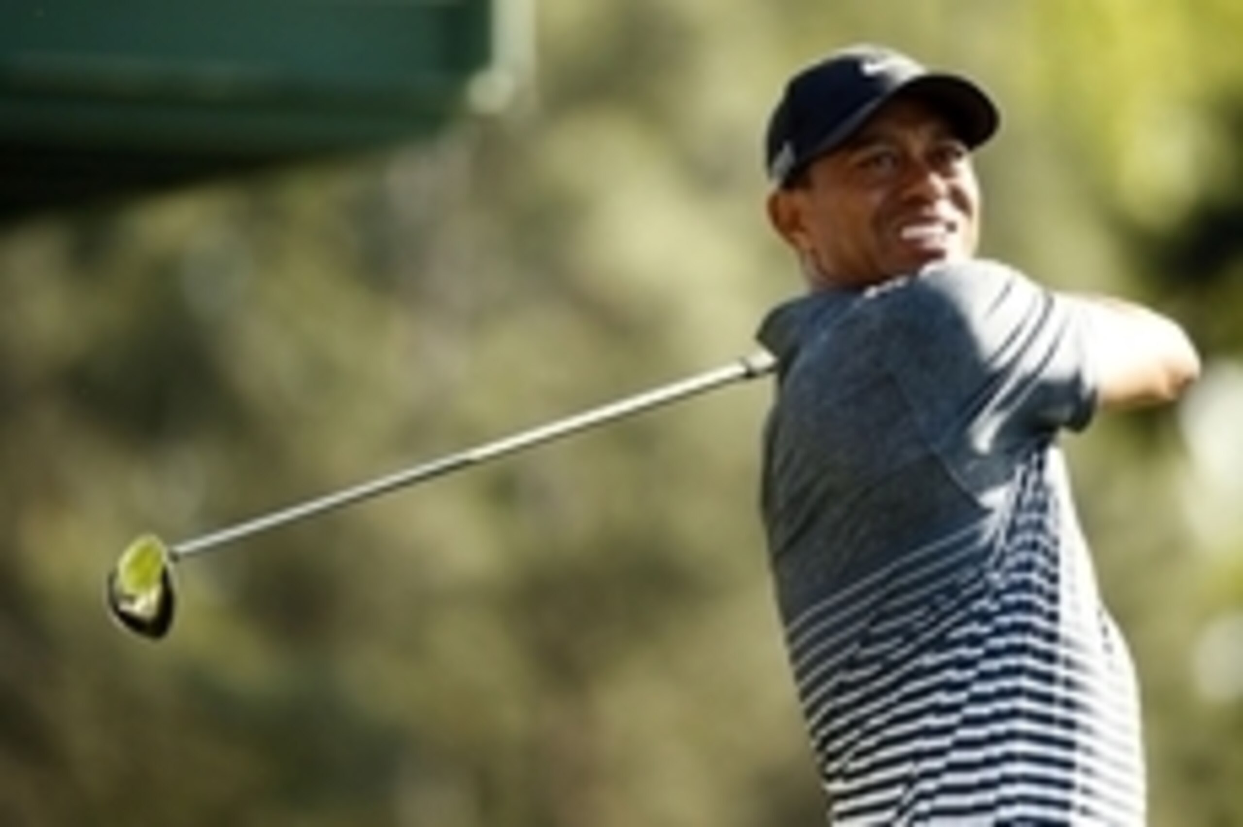 Apr 11, 2015; Augusta, GA, USA; Tiger Woods hits his tee shot on the 18th hole during the third round of The Masters golf tournament at Augusta National Golf Club. Mandatory Credit: Rob Schumacher-USA TODAY Sports