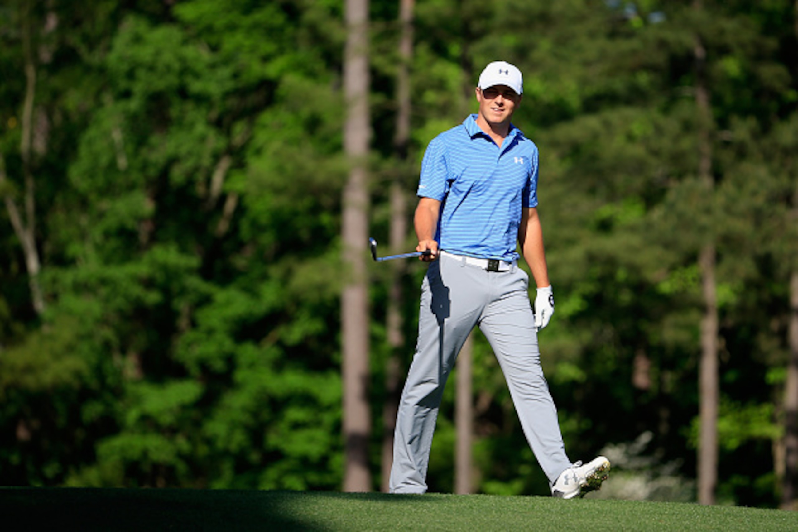 AUGUSTA, GA - APRIL 11:  Jordan Spieth of the United States smiles after his tee shot on the 12th hole during the third round of the 2015 Masters Tournament at Augusta National Golf Club on April 11, 2015 in Augusta, Georgia.  (Photo by Jamie Squire/Getty