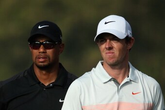 DUBAI, UNITED ARAB EMIRATES - JANUARY 31:  Tiger Woods of the USA and Rory McIlroy of Northern Ireland look on during the second round of the 2014 Omega Dubai Desert Classic on the Majlis Course at the Emirates Golf Club on January 31, 2014 in Dubai, Unit