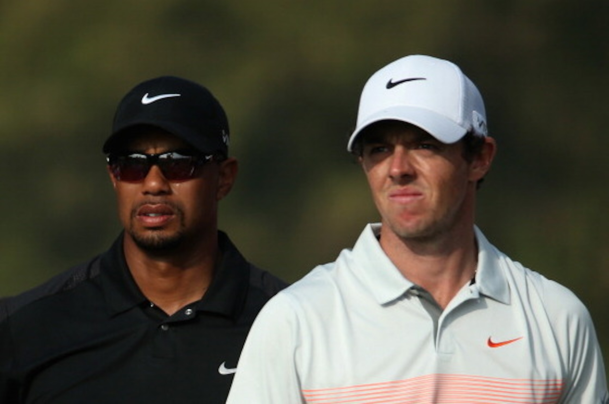 DUBAI, UNITED ARAB EMIRATES - JANUARY 31:  Tiger Woods of the USA and Rory McIlroy of Northern Ireland look on during the second round of the 2014 Omega Dubai Desert Classic on the Majlis Course at the Emirates Golf Club on January 31, 2014 in Dubai, Unit