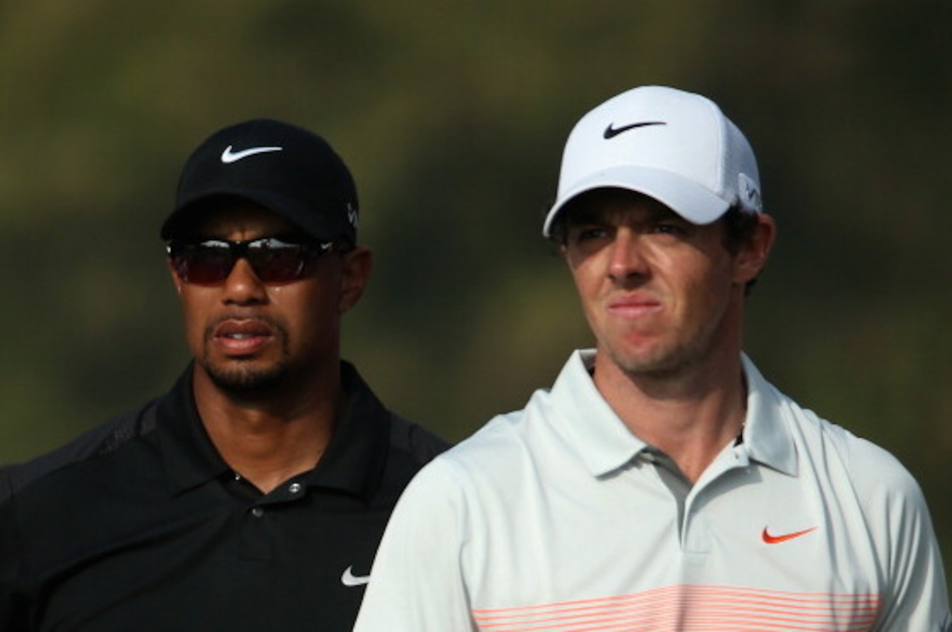 DUBAI, UNITED ARAB EMIRATES - JANUARY 31:  Tiger Woods of the USA and Rory McIlroy of Northern Ireland look on during the second round of the 2014 Omega Dubai Desert Classic on the Majlis Course at the Emirates Golf Club on January 31, 2014 in Dubai, Unit