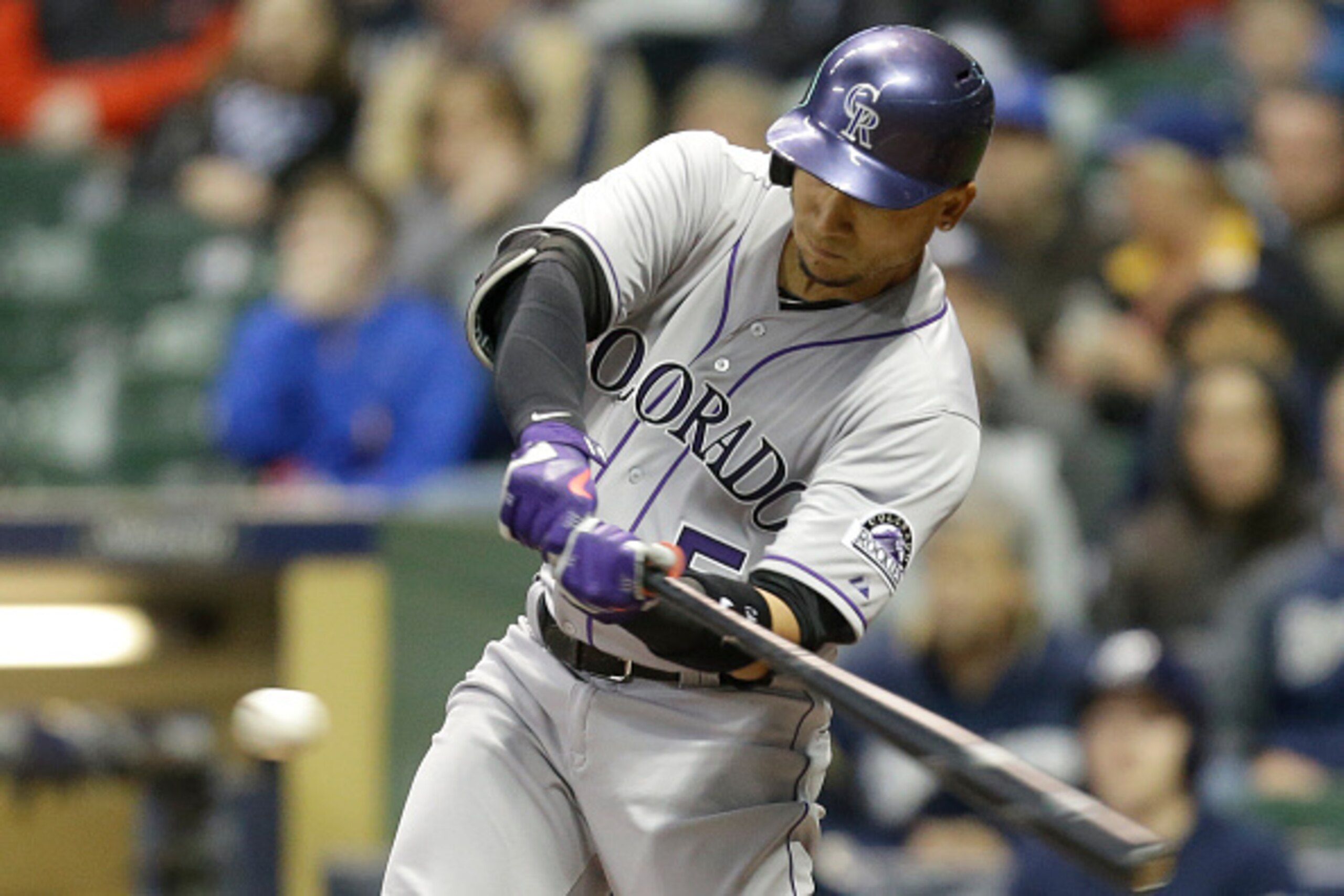 MILWAUKEE, WI - APRIL 07: Carlos Gonzalez #5 of the Colorado Rockies hits a sacrifice fly scoring Nick Hundley during the top of the sixth inning against the Milwaukee Brewers at Miller Park on April 07, 2015 in Milwaukee, Wisconsin. (Photo by Mike McGinn