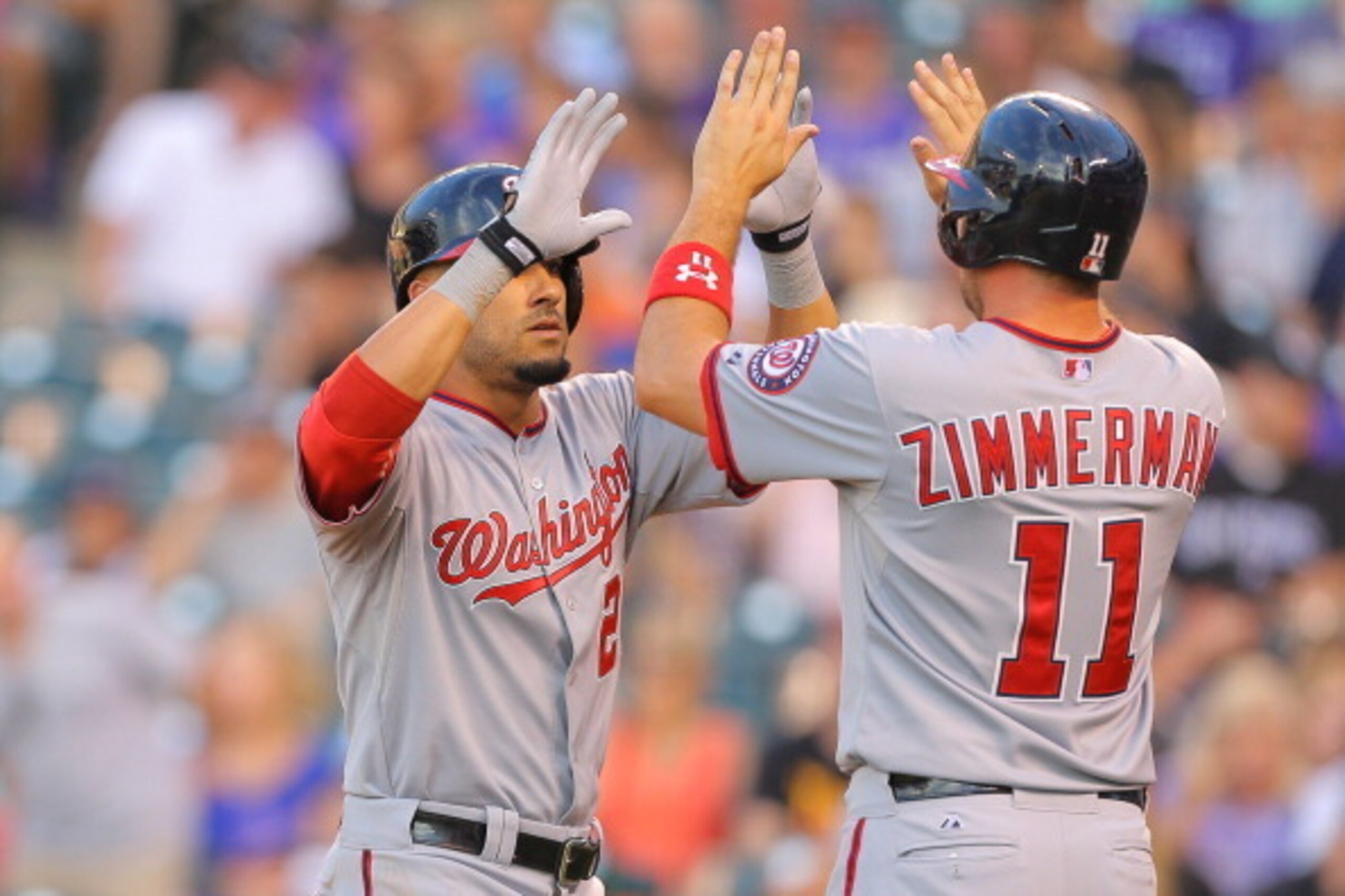 DENVER, CO - JULY 21:  Ian Desmond #20 of the Washington Nationals is congratulated by Ryan Zimmerman #11 after hitting a two-run home run during the fourth inning against the Colorado Rockies at Coors Field on July 21, 2014 in Denver, Colorado.  (Photo b