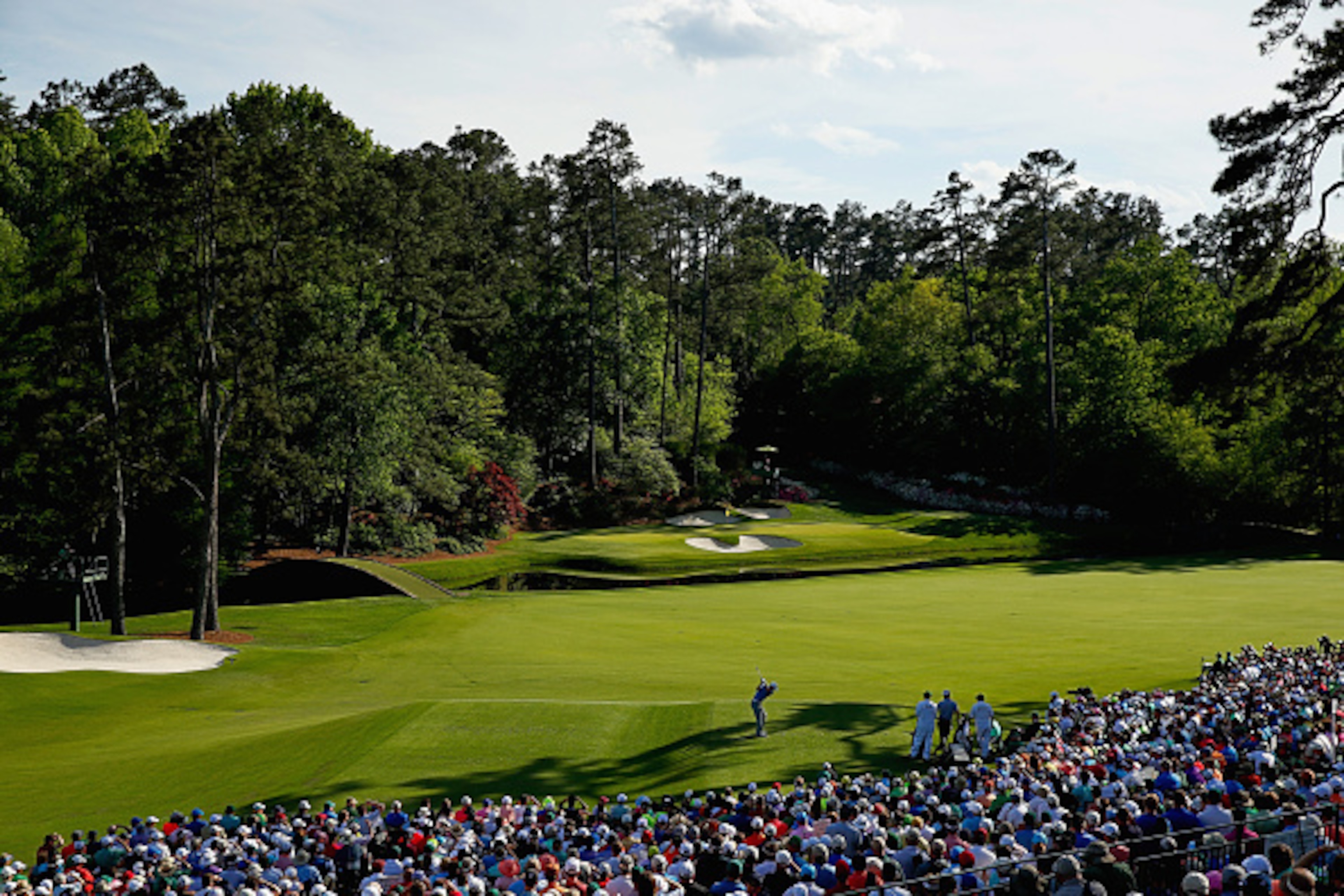 AUGUSTA, GA - APRIL 11: Jordan Spieth of the United States hits his tee shot on the 12th hole as Charley Hoffman of the United States looks on during the third round of the 2015 Masters Tournament at Augusta National Golf Club on April 11, 2015 in Augusta
